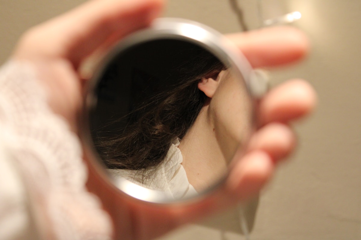 A person holding a mirror in their hand