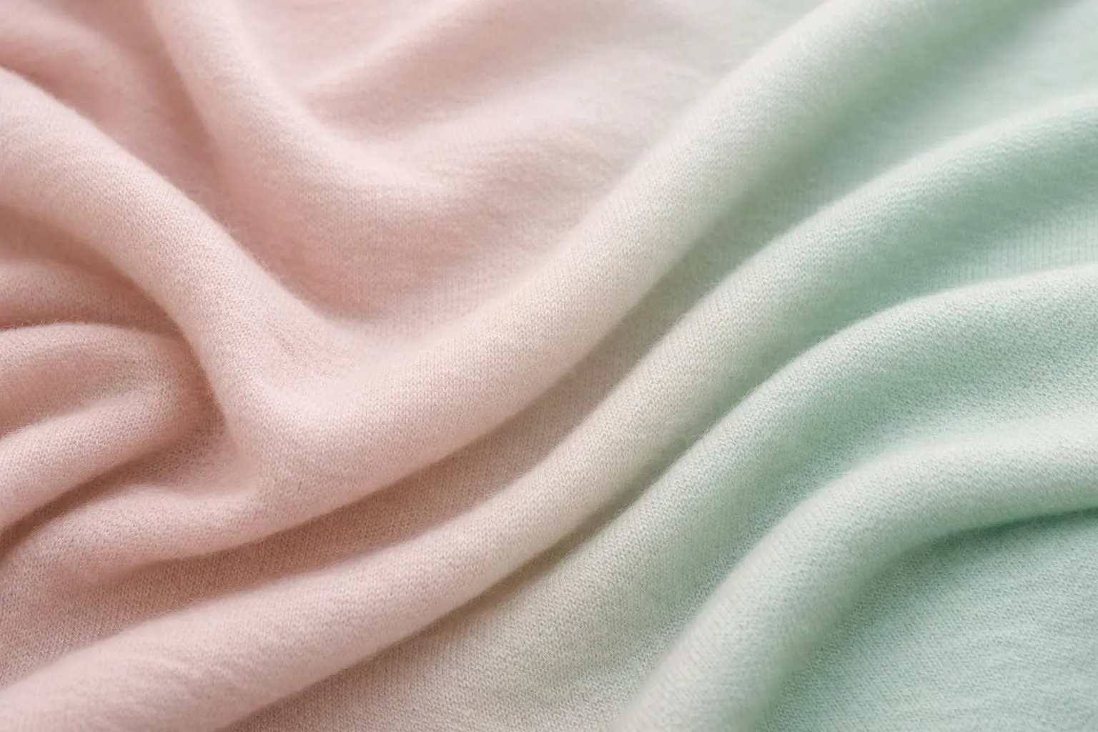 Close-up of luxurious merino wool fabric in soft neutral tones, showing the fine textile texture and natural drape, with elegant lighting highlighting the material's quality and softness, perfect for women's travel clothing