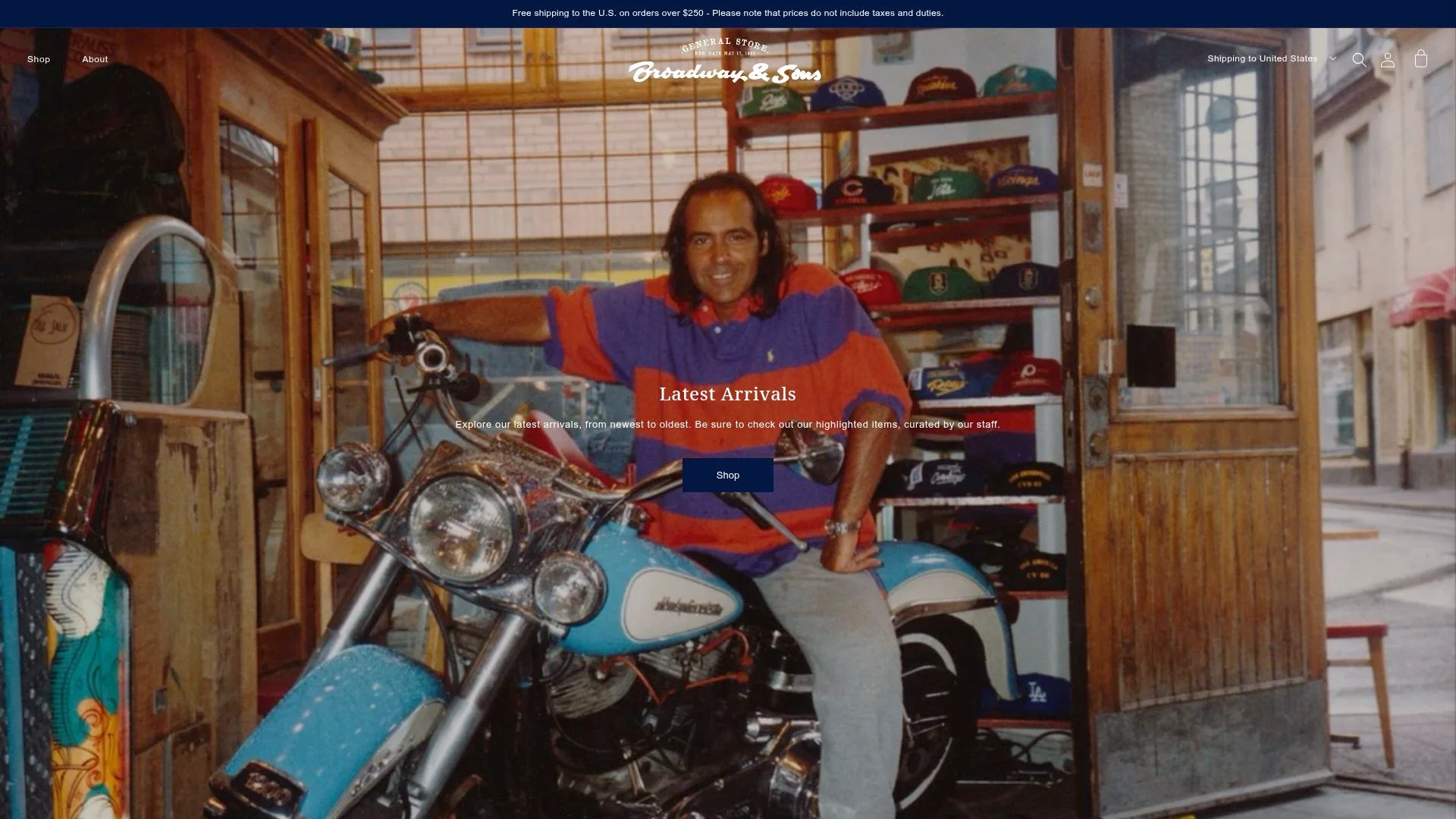 A smiling man posing with a vintage motorcycle in a store.