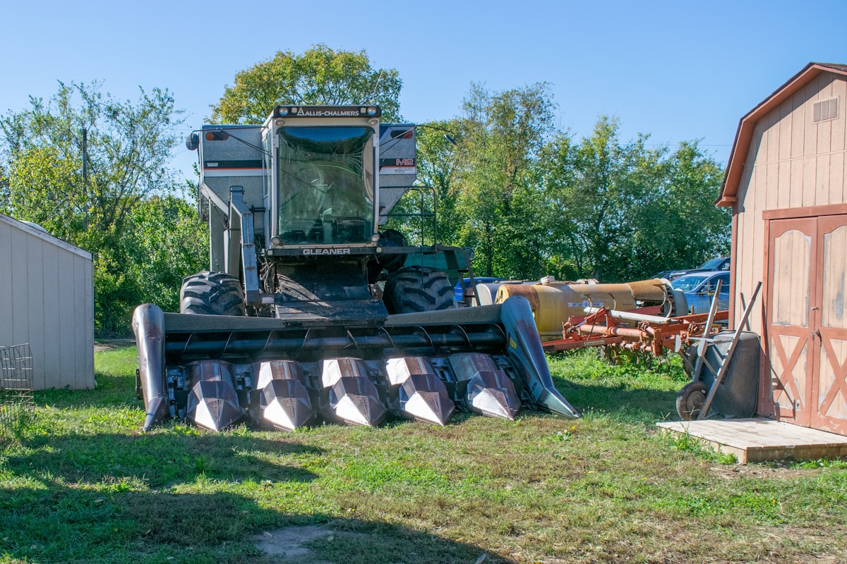 a tractor is parked next to a barn