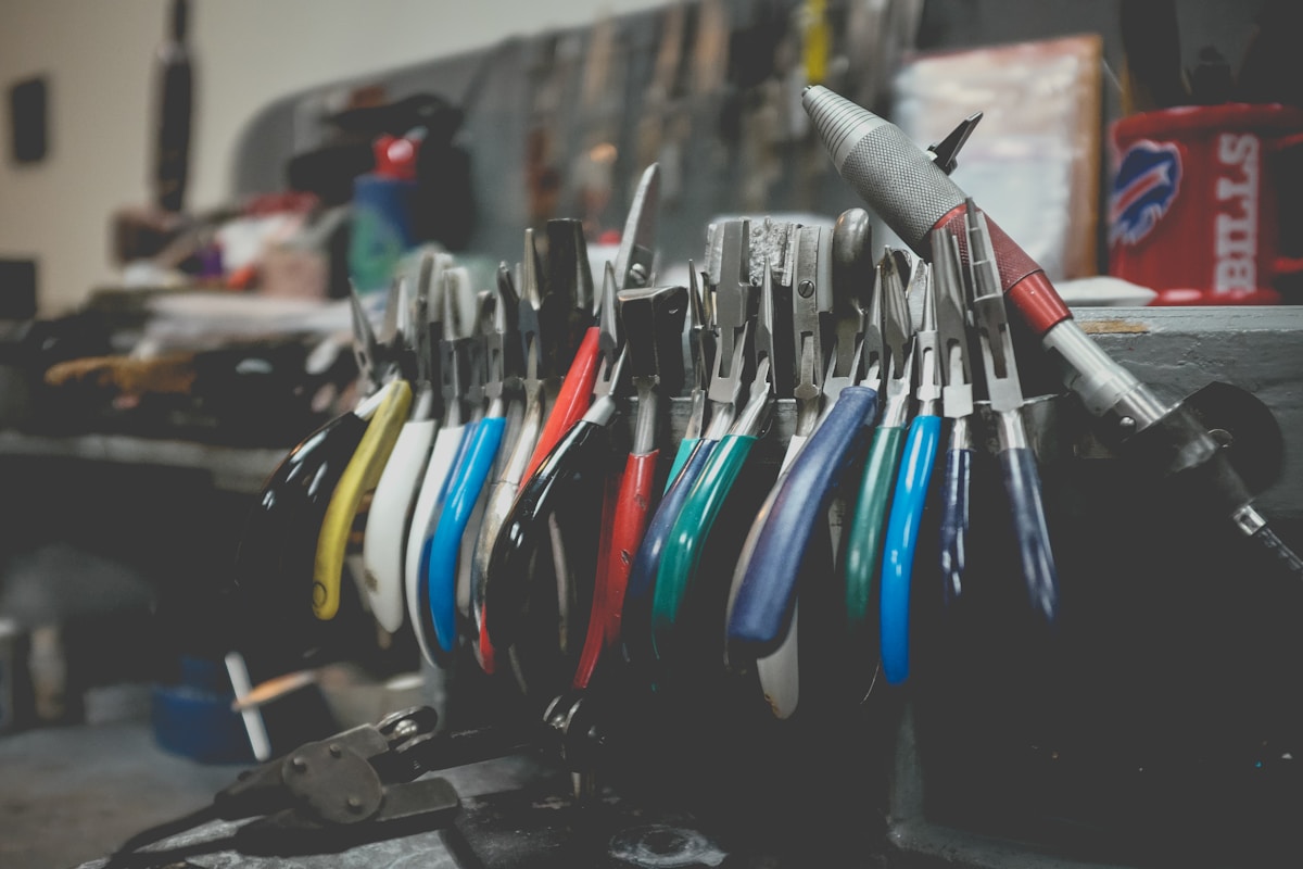 Outils de bricolage colorés et variés sur un établi.