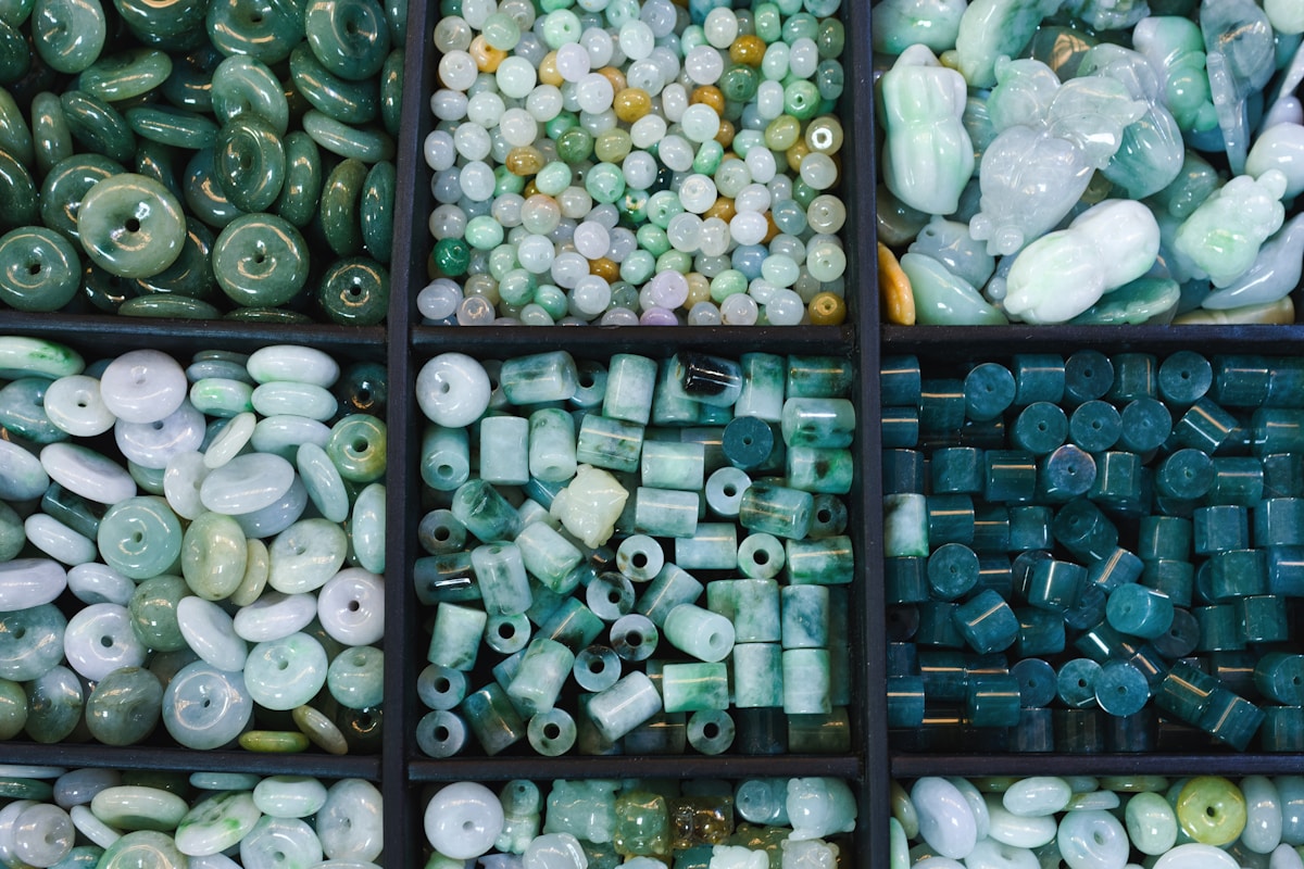 Assortiment varié de perles et de pierres semi-précieuses vertes et bleues.