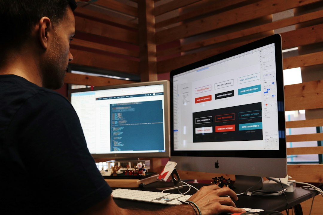 Développeur web sur laptop, montrant mockups et wireframes de redesign dans bureau moderne – prix refonte site internet