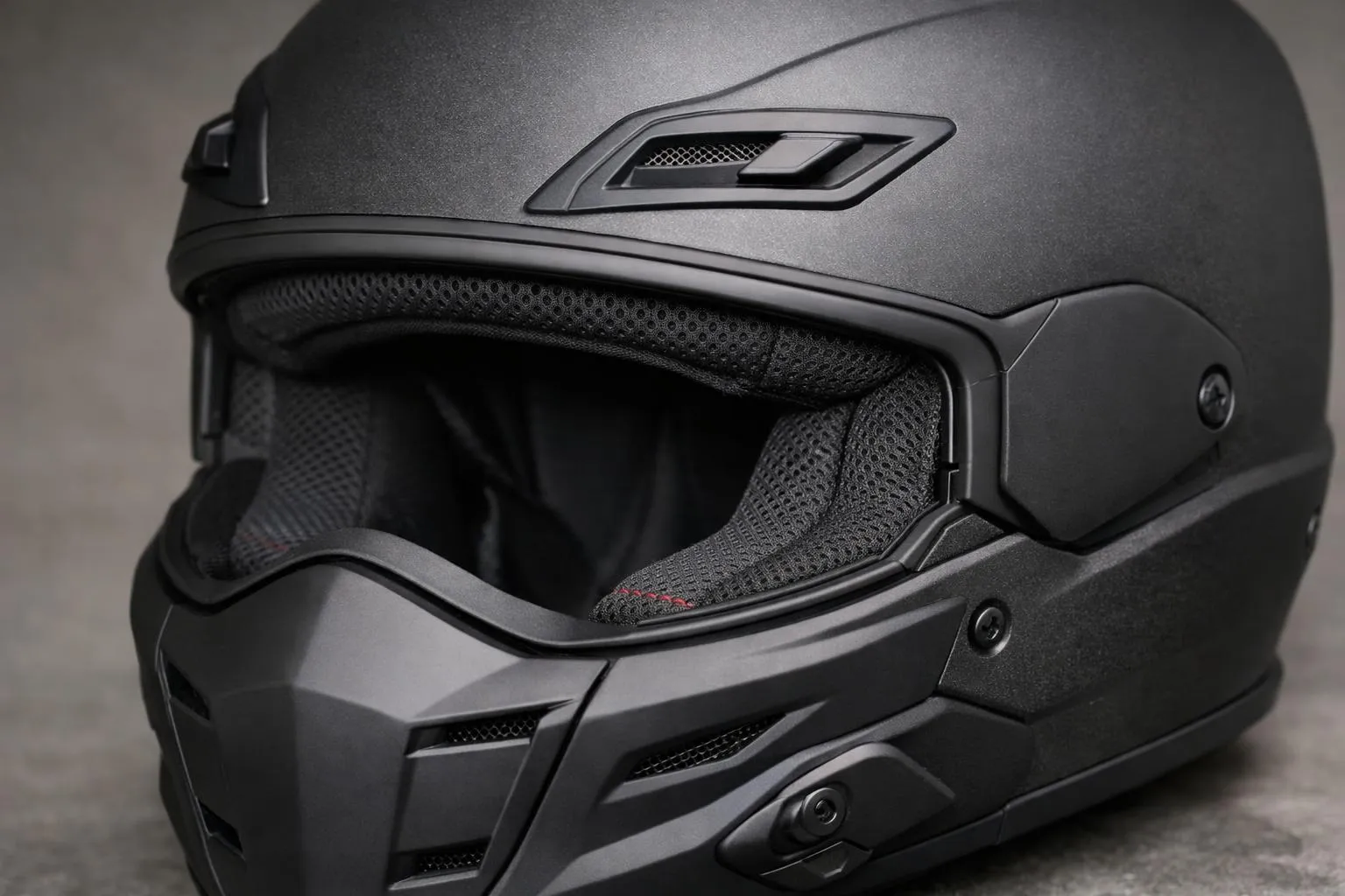 Un casque de moto Scorpion Exo-Combat Evo avec des canaux de ventilation, un rembourrage confortable et une coque en polycarbonate, photographié avec un éclairage doux.