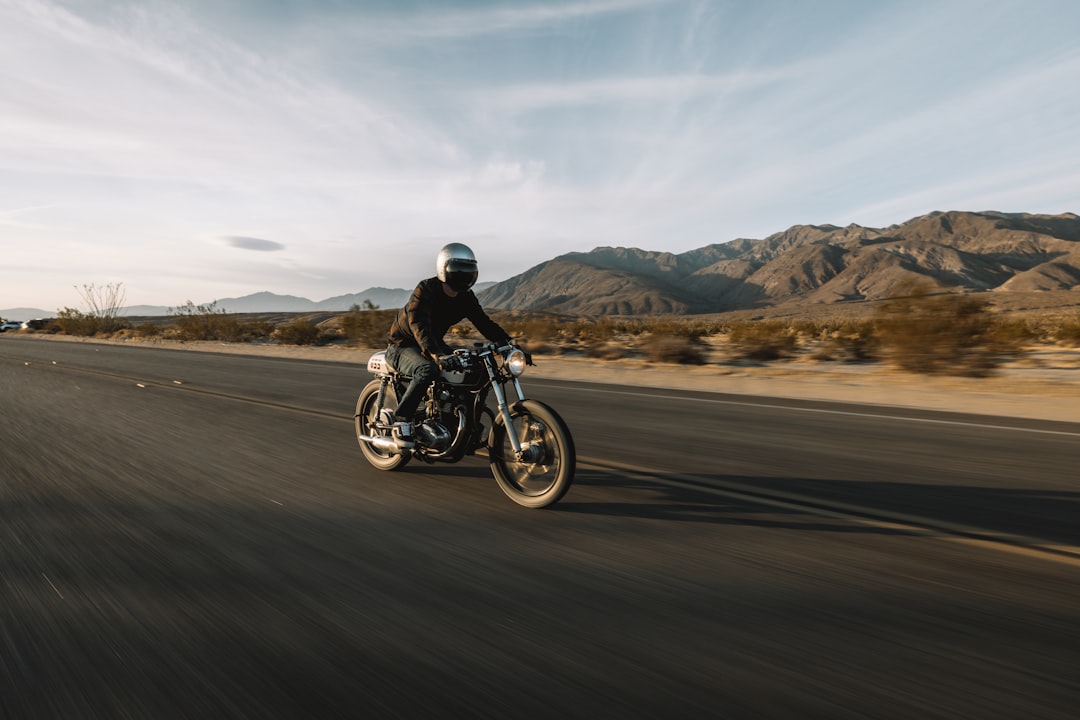 ride en moto - man riding motorcycle on road during daytime
