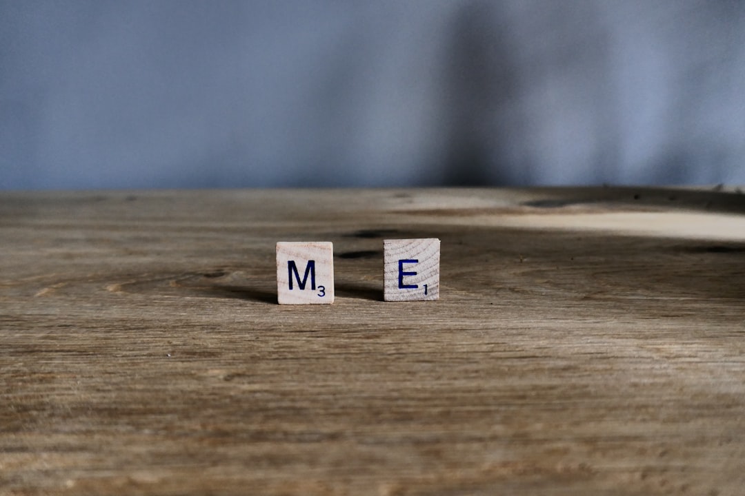 na me - Scrabble tiles spell out me on wooden surface