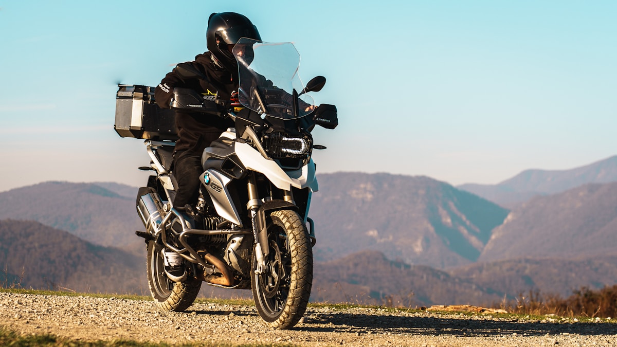 Moto tout-terrain BMW sur un chemin de montagne.