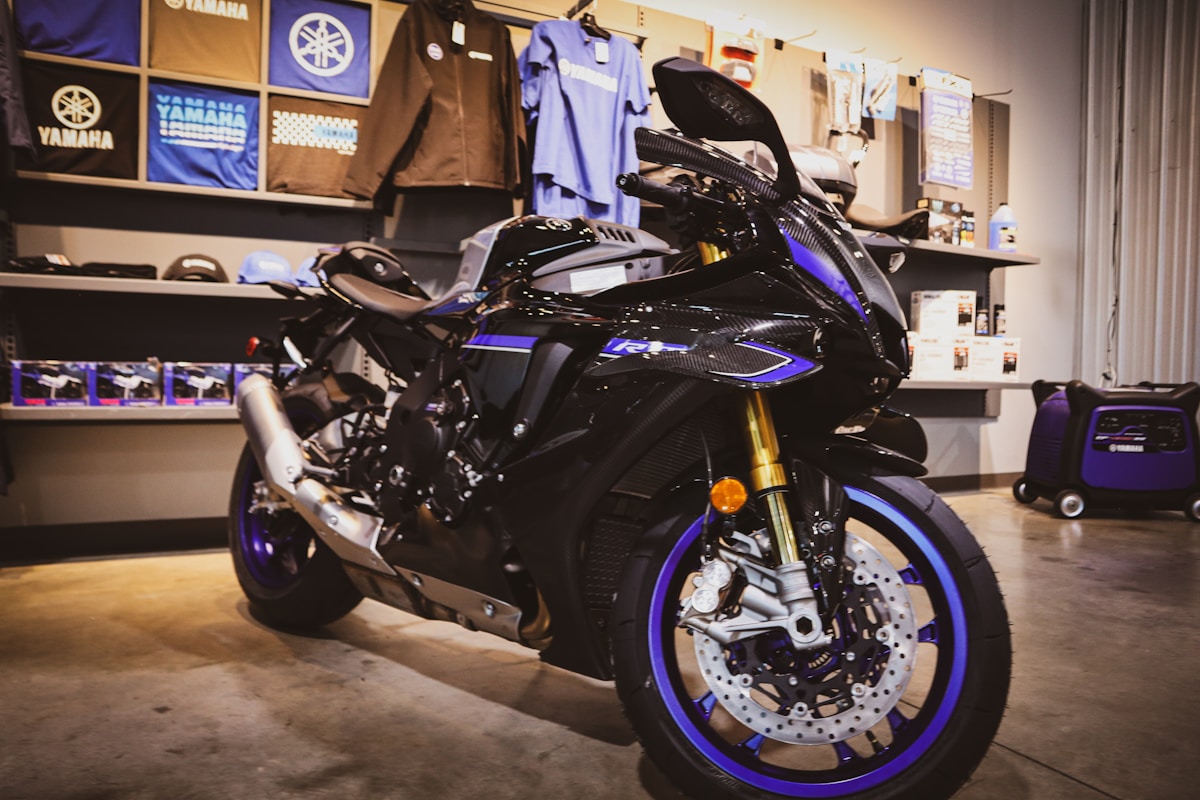 Moto de sport noire et bleue dans un magasin de motos.