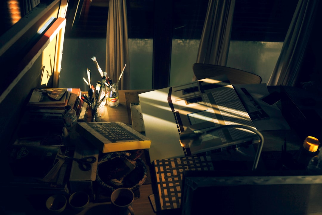 Just a picture of someone at a messy desk, looking totally stressed and buried under a stack of papers—you know, the classic frustrations of manual content creation.