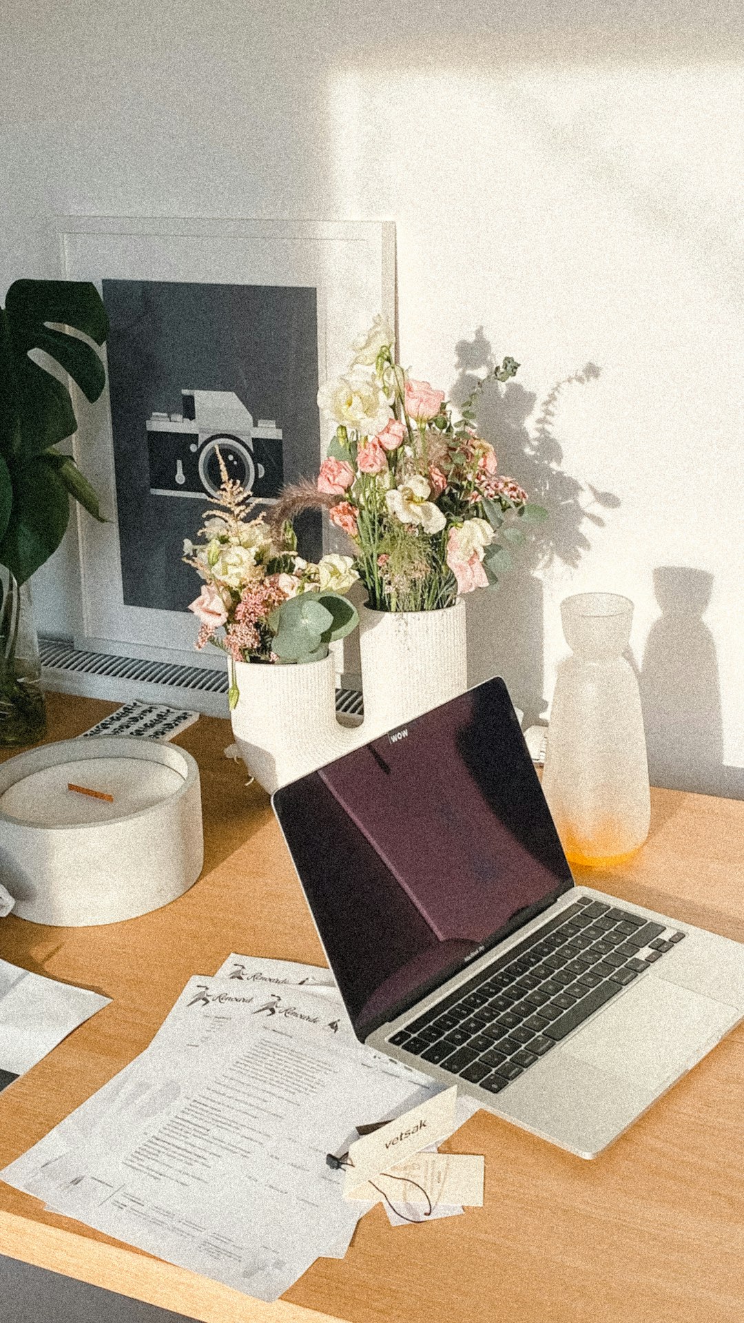A clean, simple workspace with a laptop, notebook, and a plant, giving off a vibe of being organized and ready to plan.