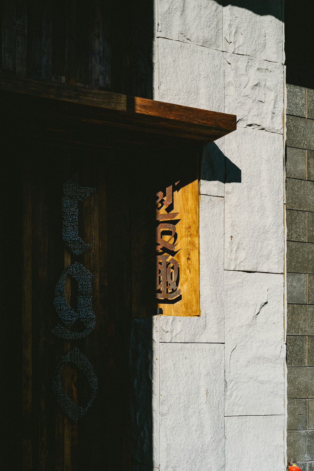 Close-up of a rustic wooden 'OPEN' sign hanging on the glass door of a charming small boutique or cafe. Photo by Tim Mossholder on Unsplash.