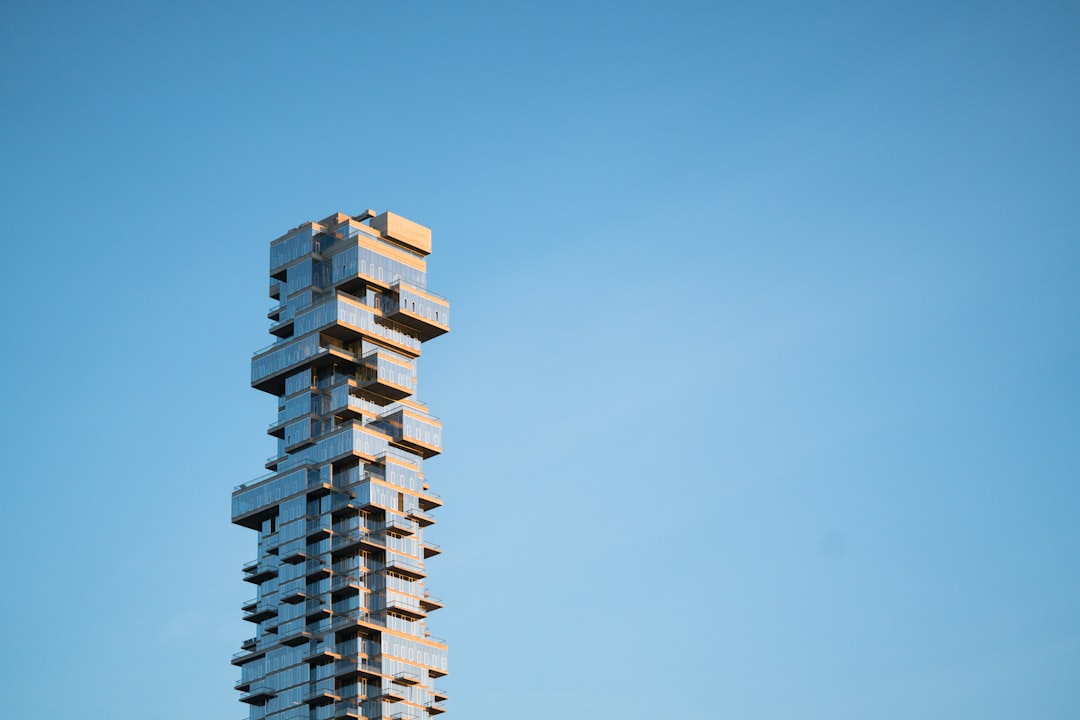 A close-up of someone's hand carefully placing a wooden block on a wobbly tower, which is a great metaphor for the precision and care you need for manual vetting.