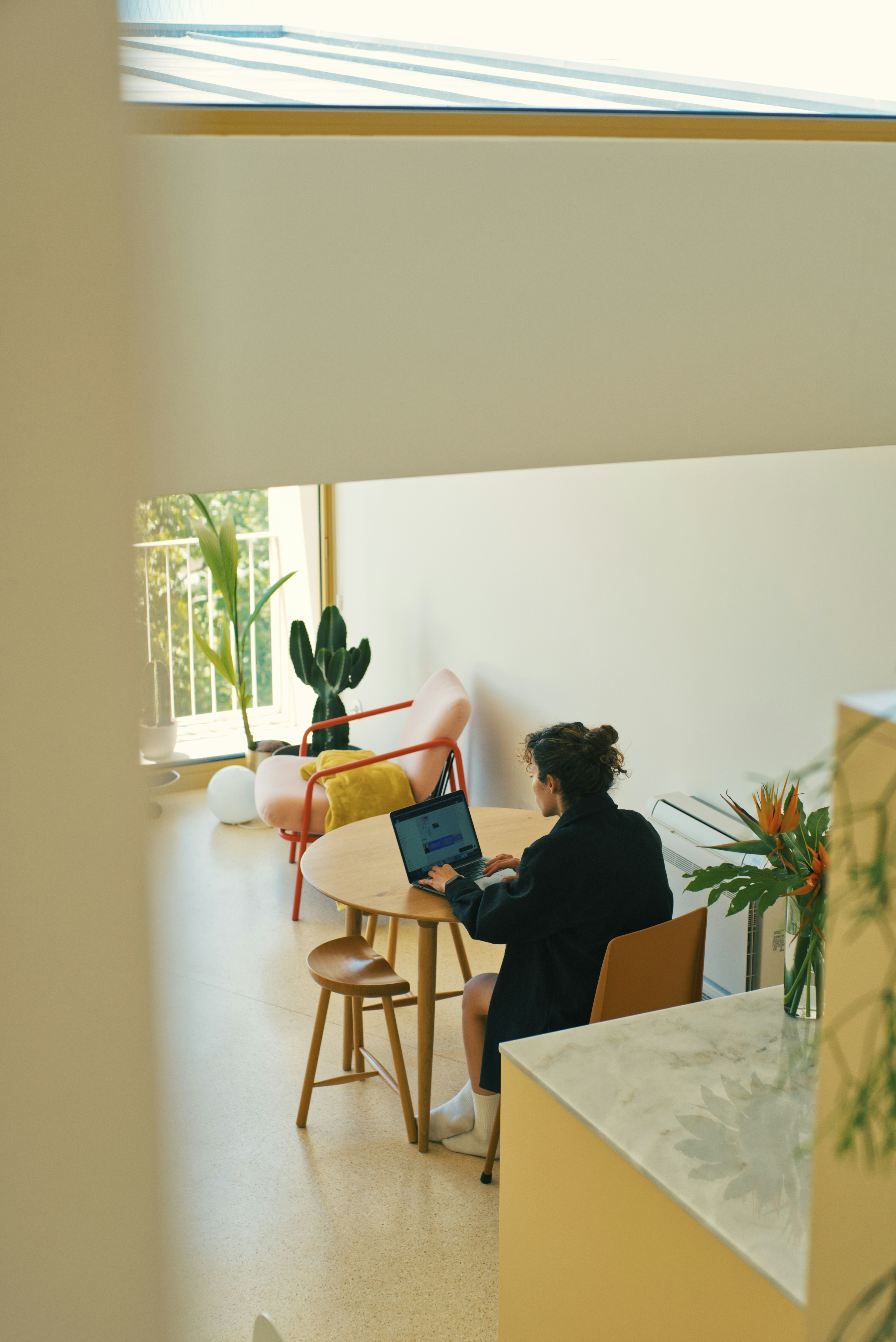 A person looking intently at a laptop screen in a cozy, softly lit room, looking like they're planning their next big business move.