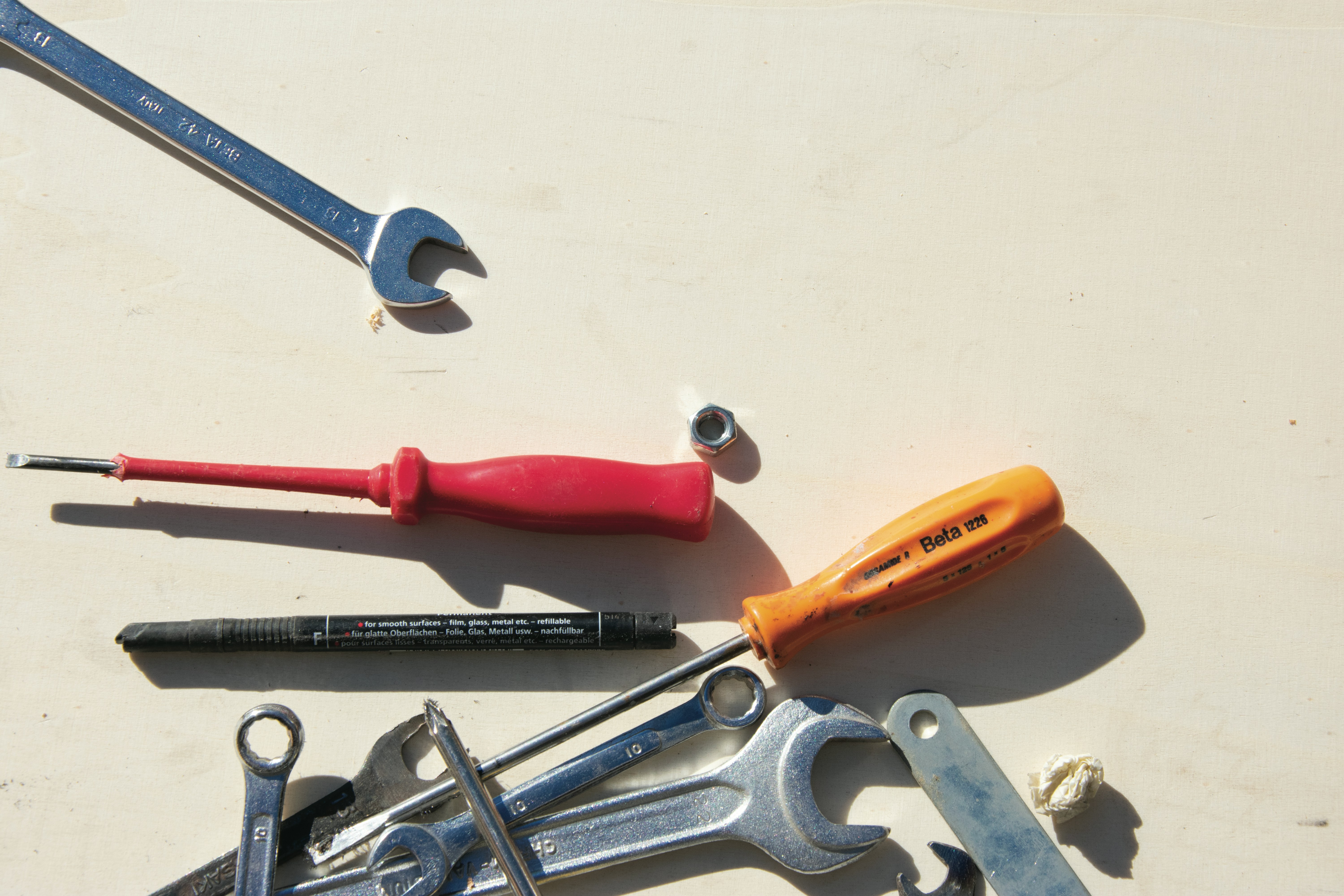 A well-organized toolbox with screwdrivers and Allen keys laid out neatly on a clean wooden surface, ready for a DIY project.