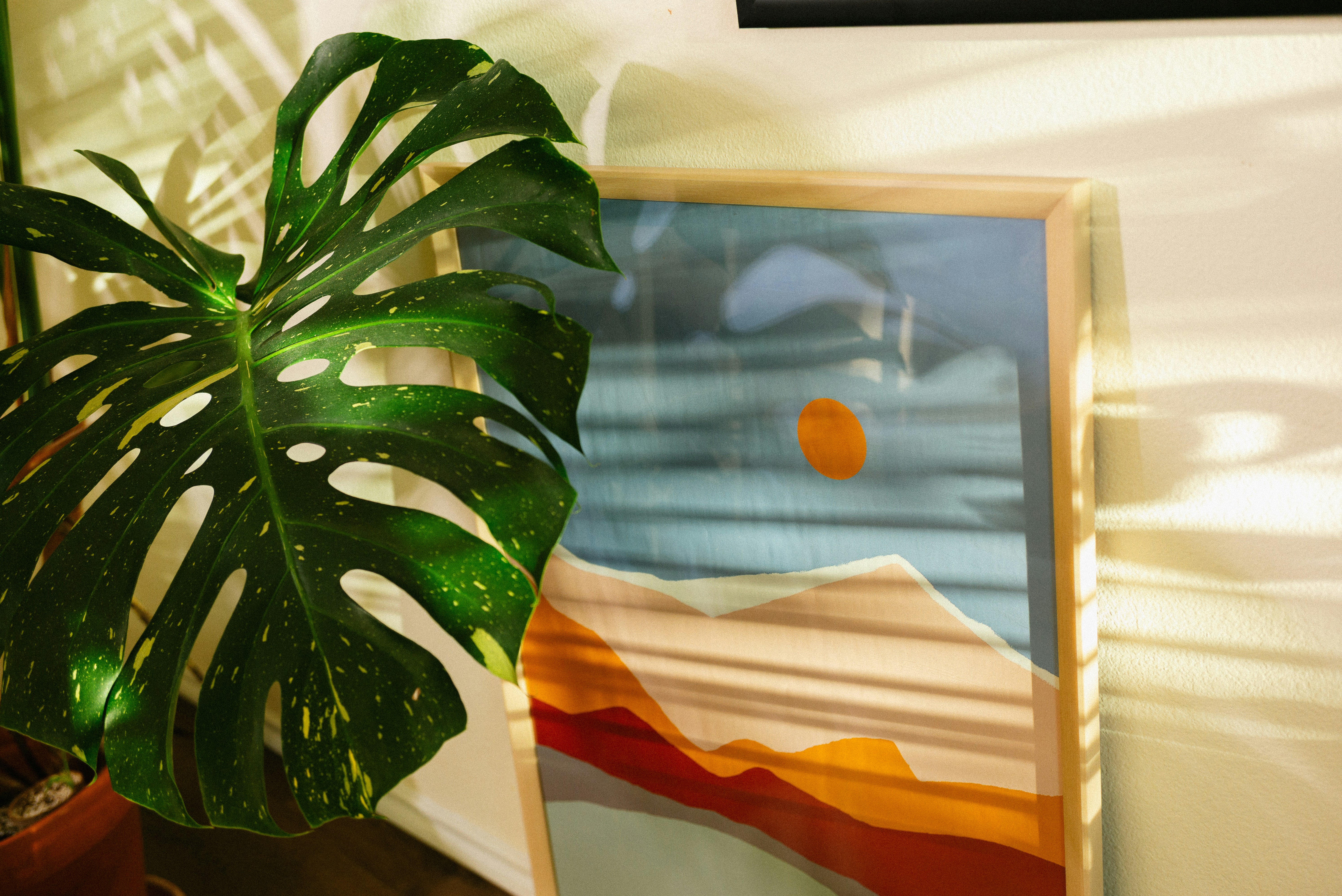 A painter stands proudly in their well-lit art studio, surrounded by canvases and supplies, looking thoughtfully at a finished piece.