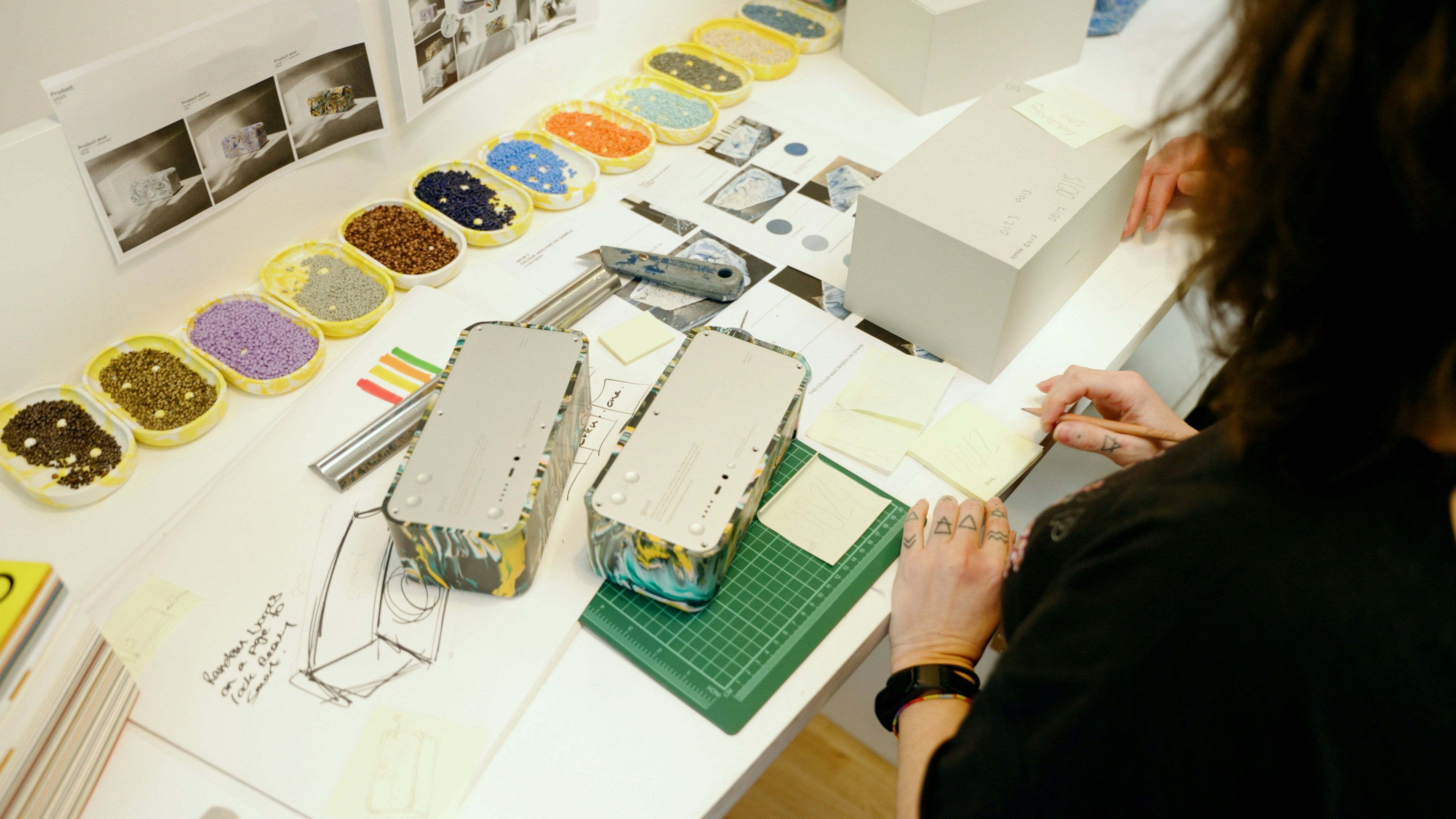 A designer making careful adjustments to a physical model, which represents the desire for total, pixel-perfect control.