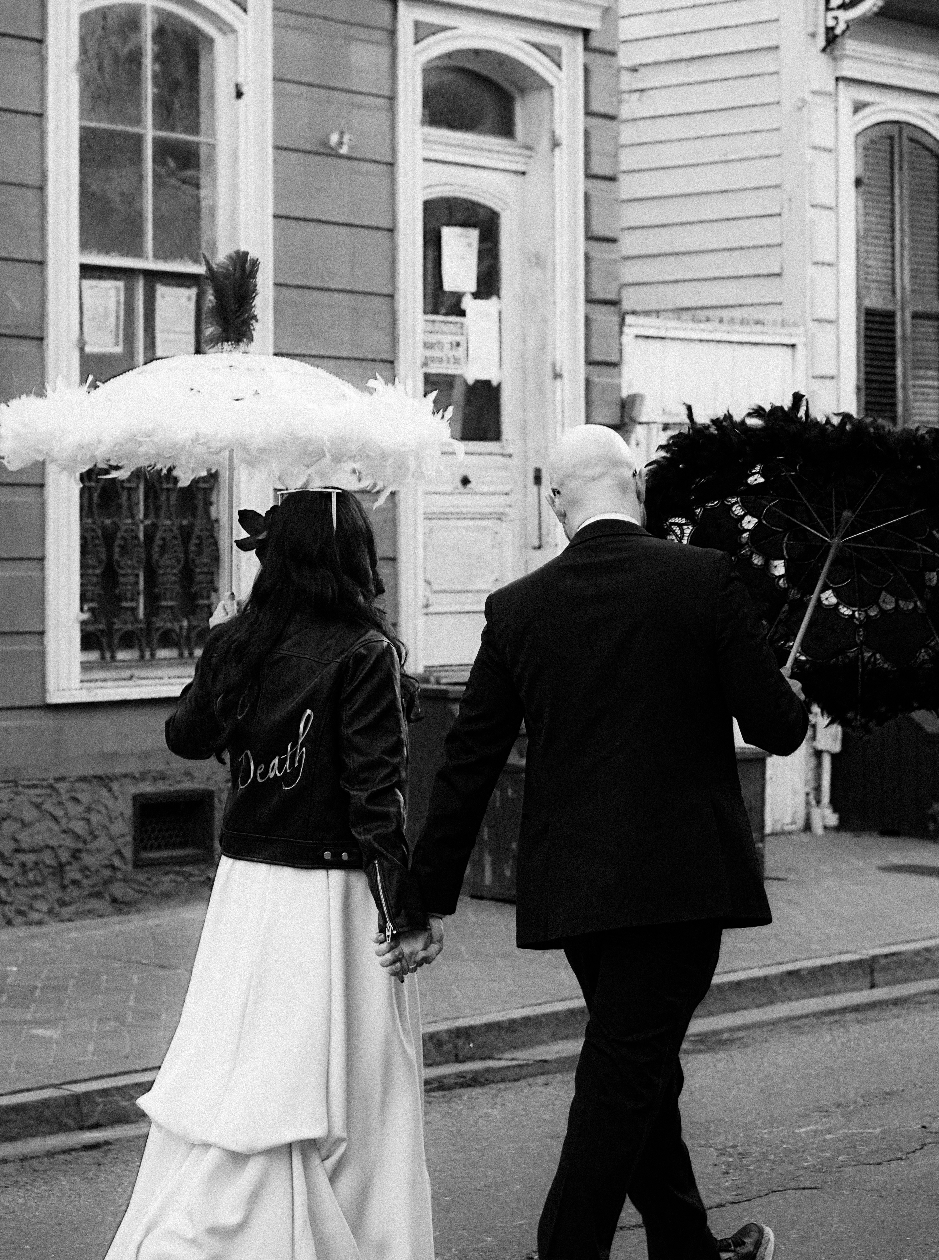 Une image en noir et blanc d'un père ému regardant sa fille marcher vers l'autel, capturée de manière discrète pendant une cérémonie de mariage.