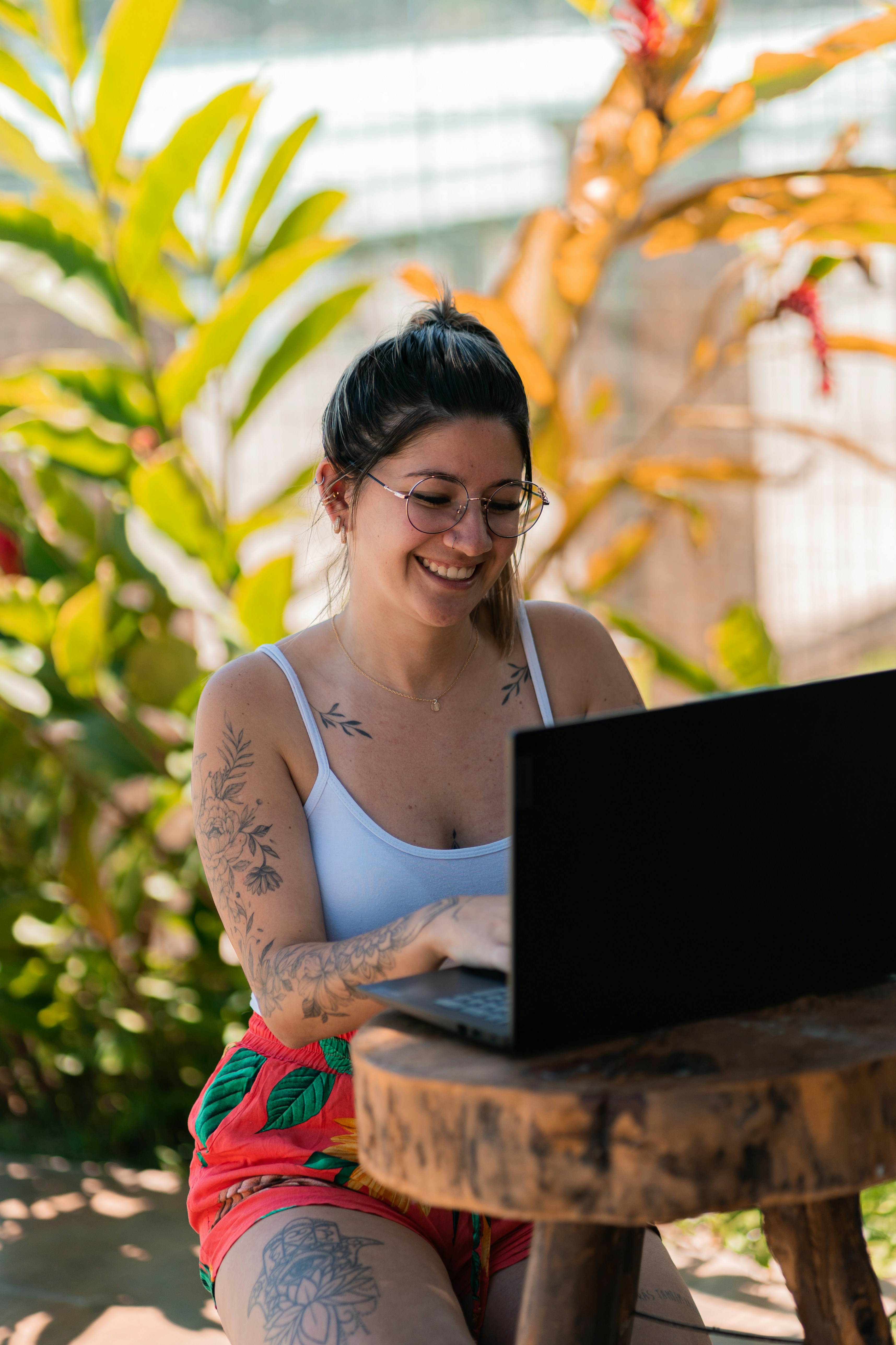 A person smiling while looking at a laptop, indicating satisfaction with the software they are using.