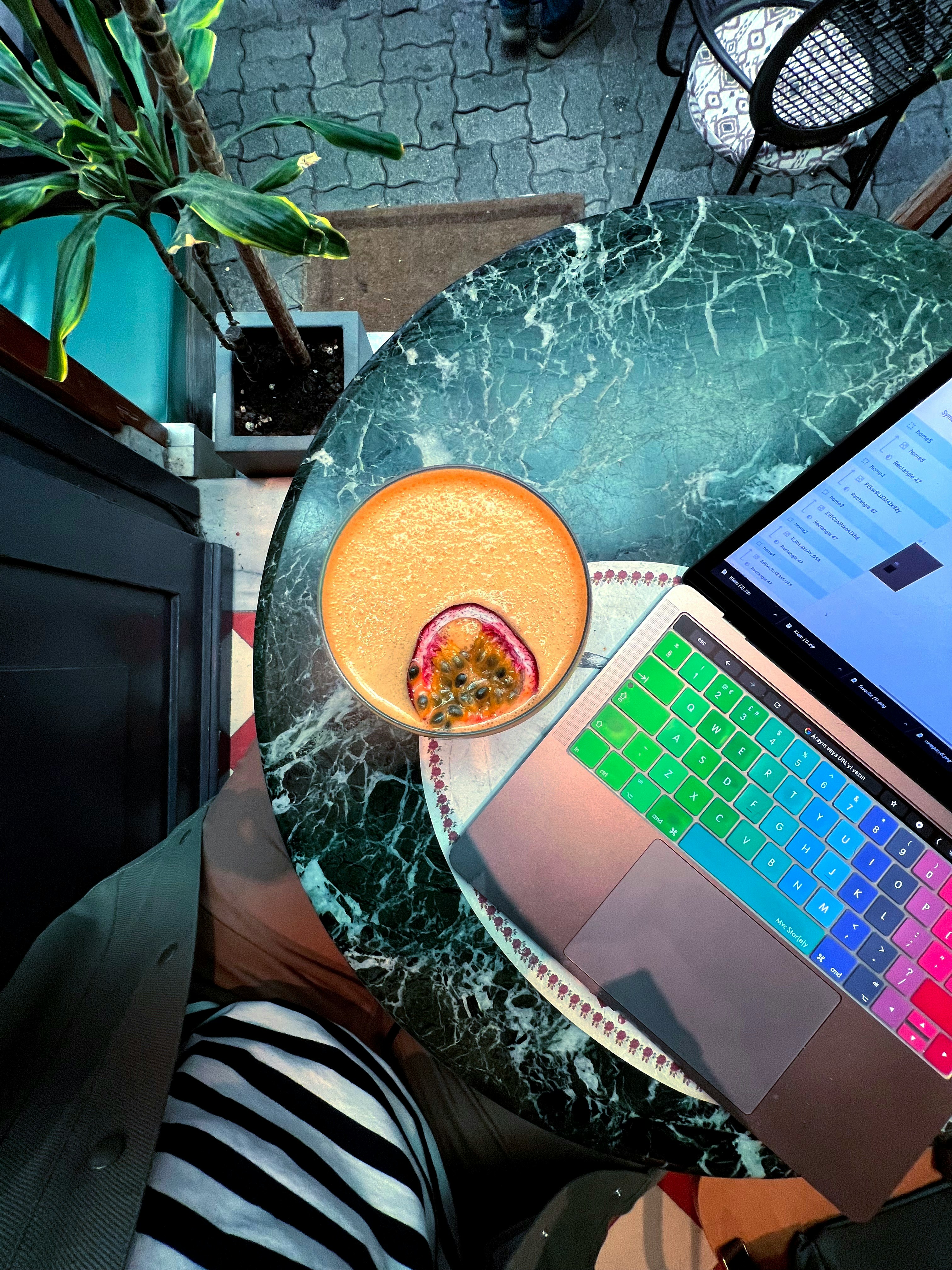 A thoughtful freelancer sitting at a desk with a laptop, looking at lines of code on one screen and a visually designed website on another, pondering the choice between code and a visual editor.