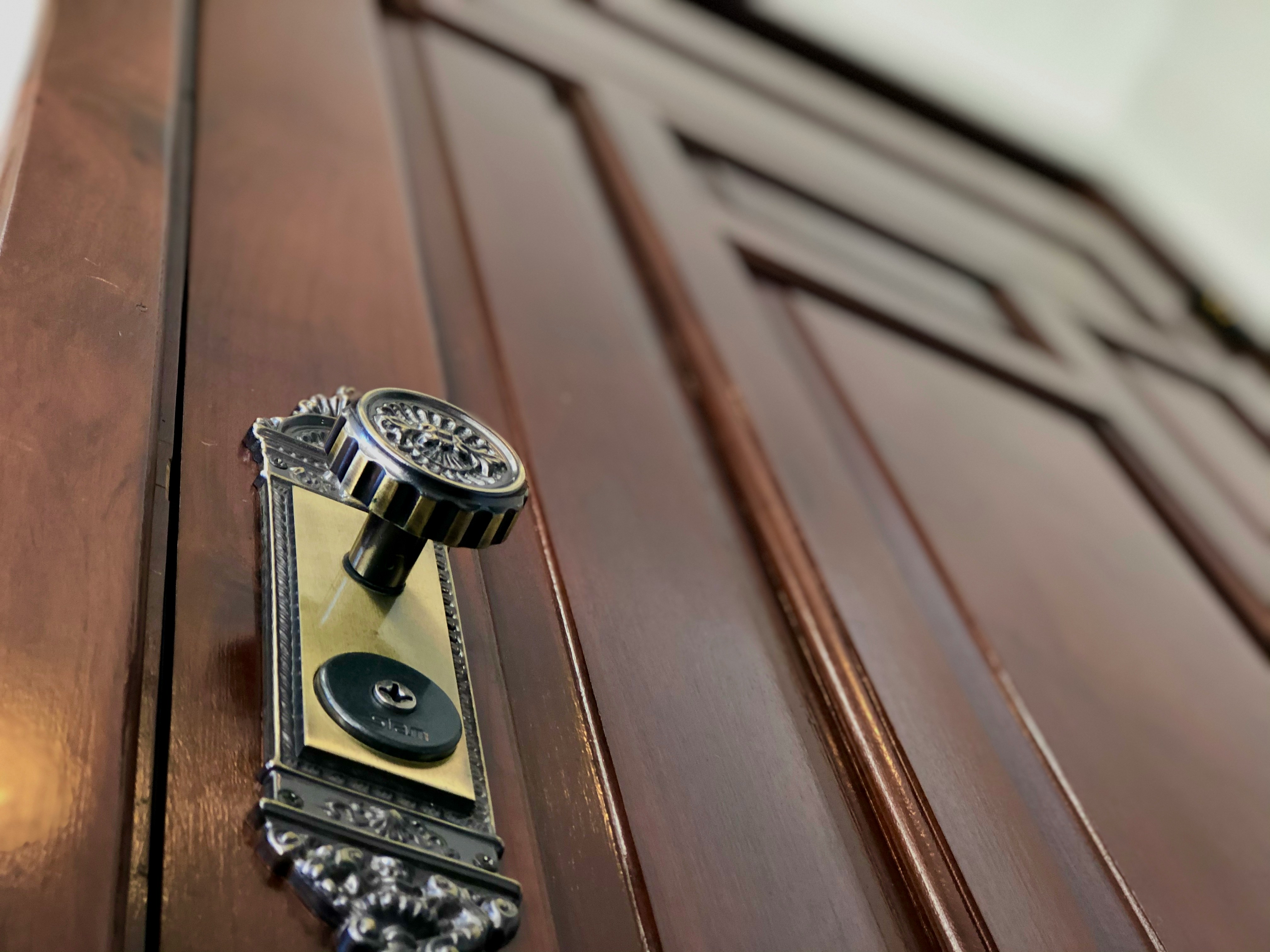 Close-up of a set of house keys resting on a wooden table, symbolizing the handover of property management.
