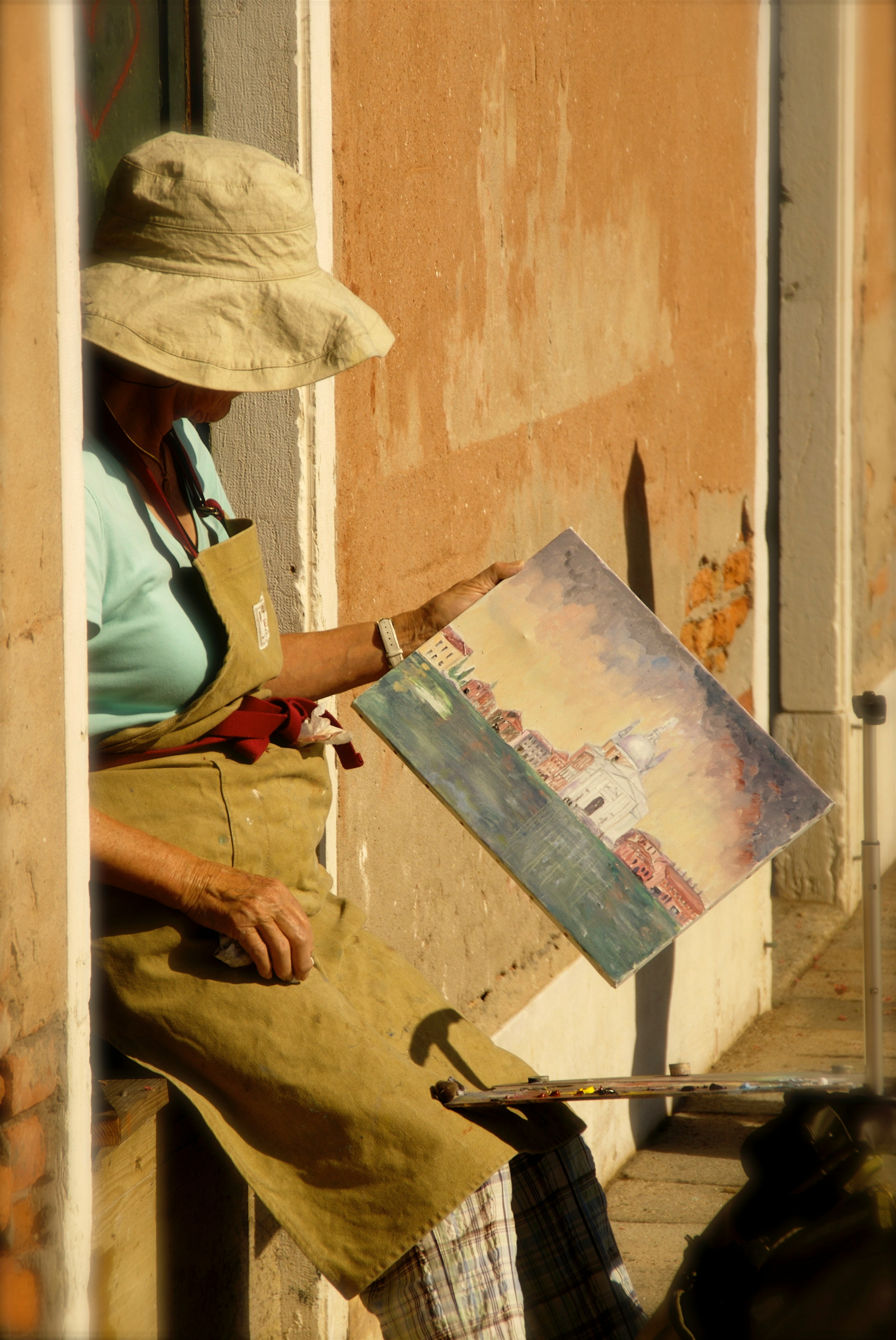 A close-up of an artist's hands in the middle of creating, whether it's playing piano, holding a paintbrush, or strumming a guitar.