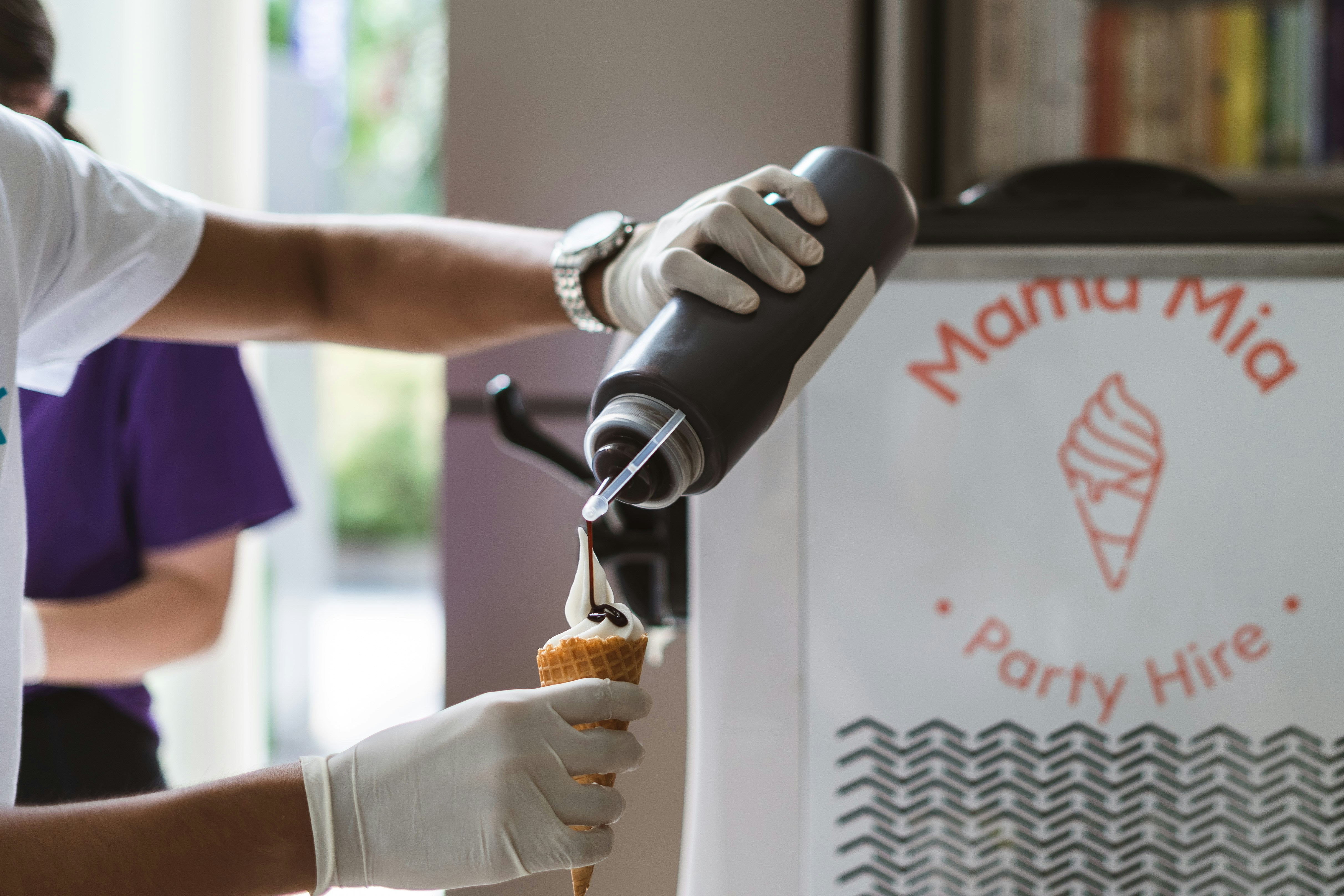 Un technicien professionnel en uniforme installe avec soin une moustiquaire enroulable sur une fenêtre, utilisant des outils spécialisés.