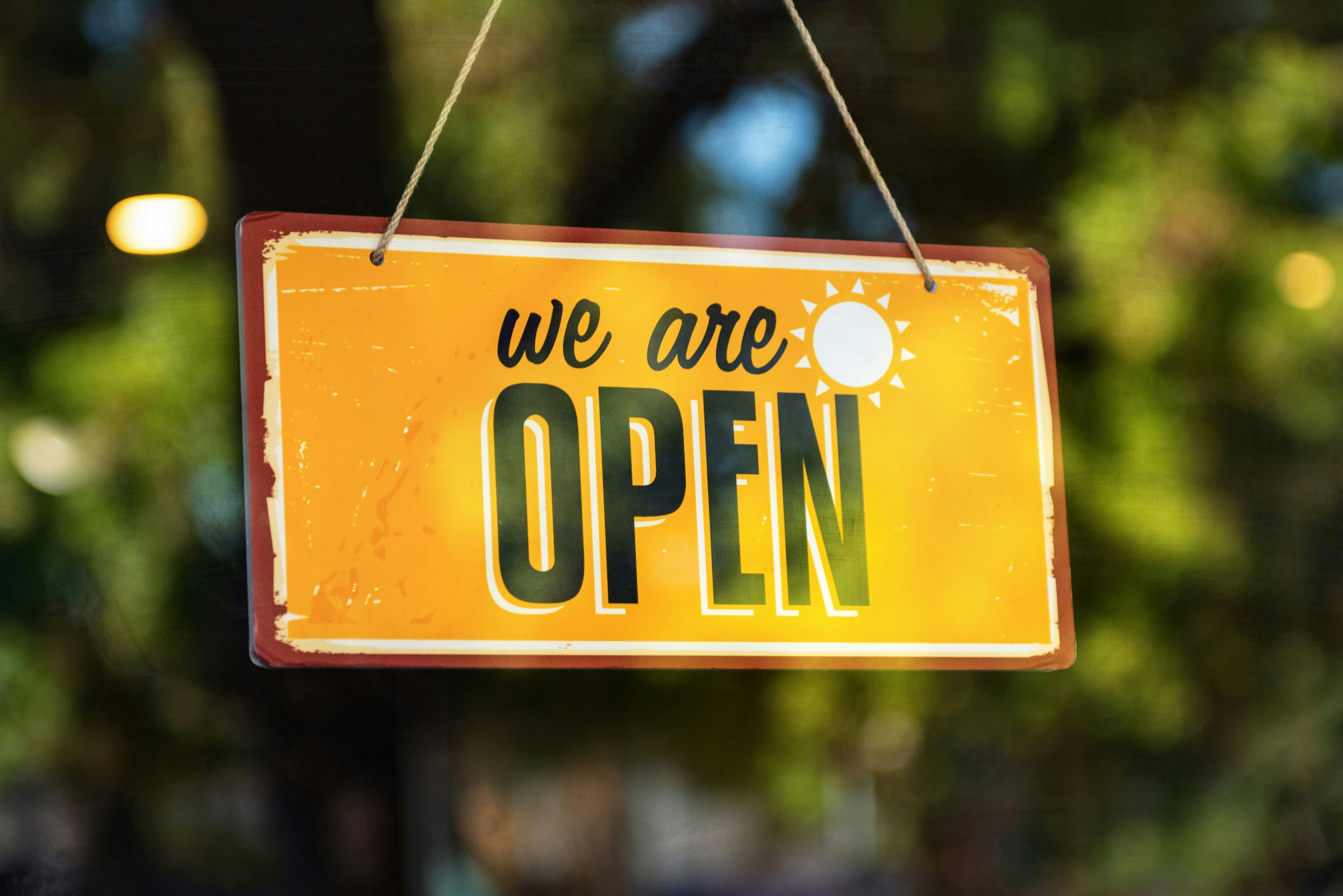 The inviting storefront of a bustling local bookstore or cafe, showing what a successful small business looks like.