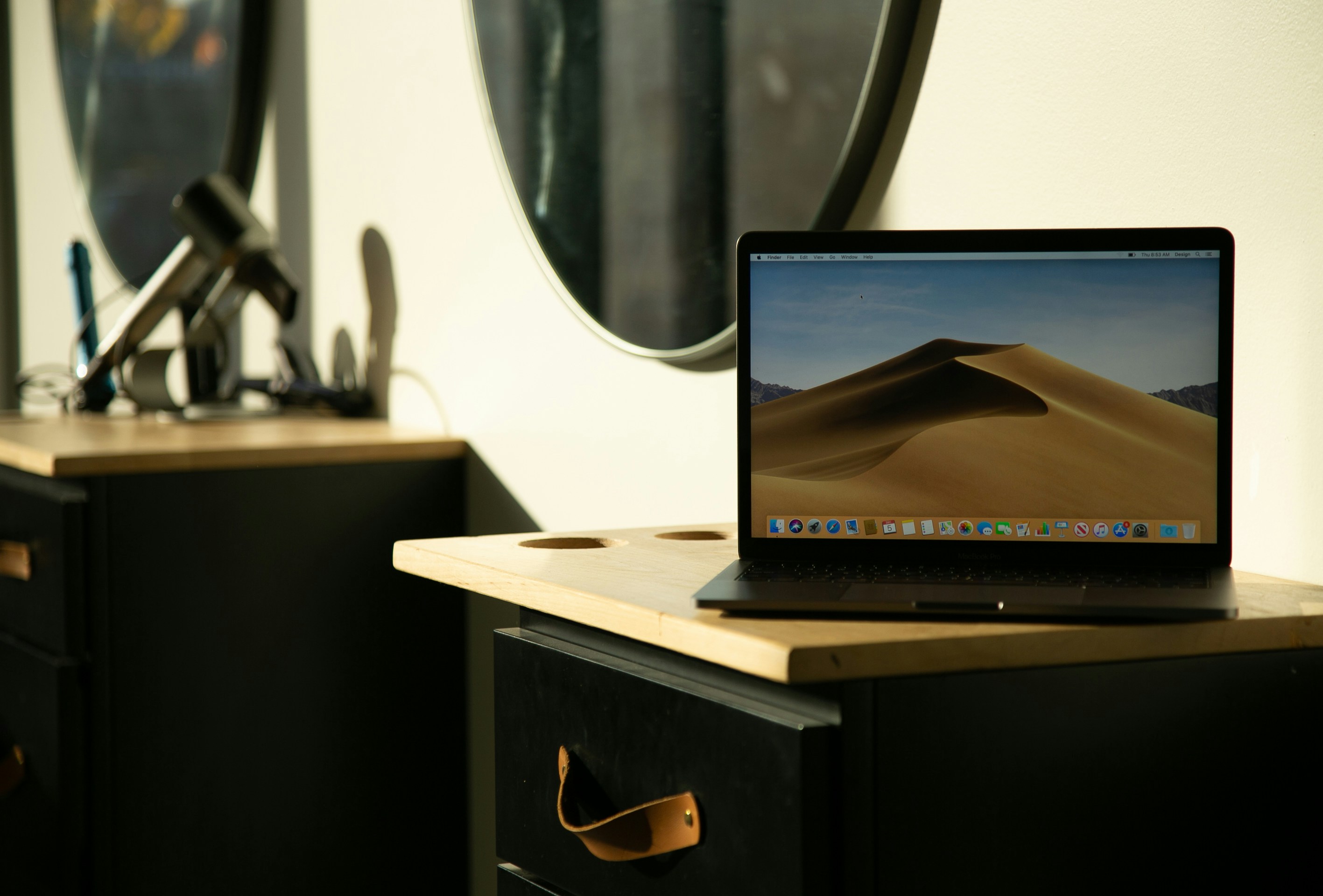 A modern, minimalist desk setup with a laptop displaying a beautifully designed website, emphasizing a strong brand presence.