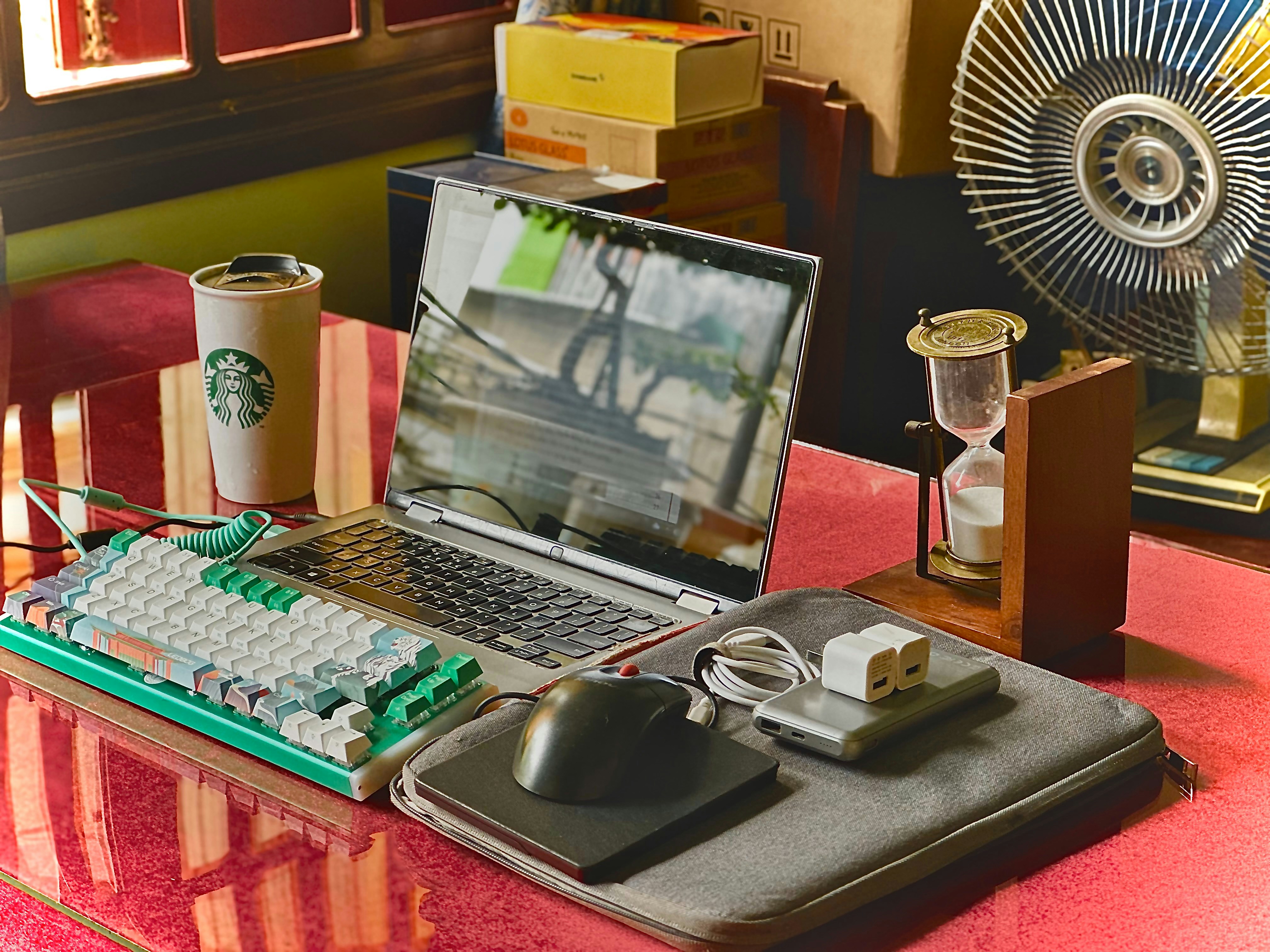 A person working at a clean desk with a laptop, a notebook, and a cup of coffee, suggesting organized maintenance and updates.