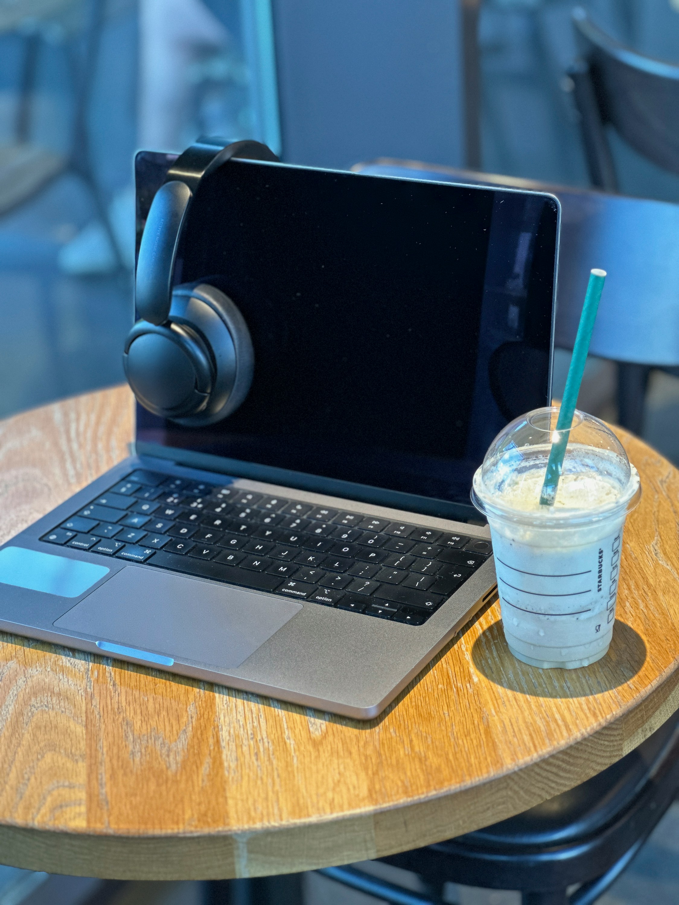 A stylish and modern desk setup with a laptop, notebook, and coffee, conveying a sense of professionalism and productivity.