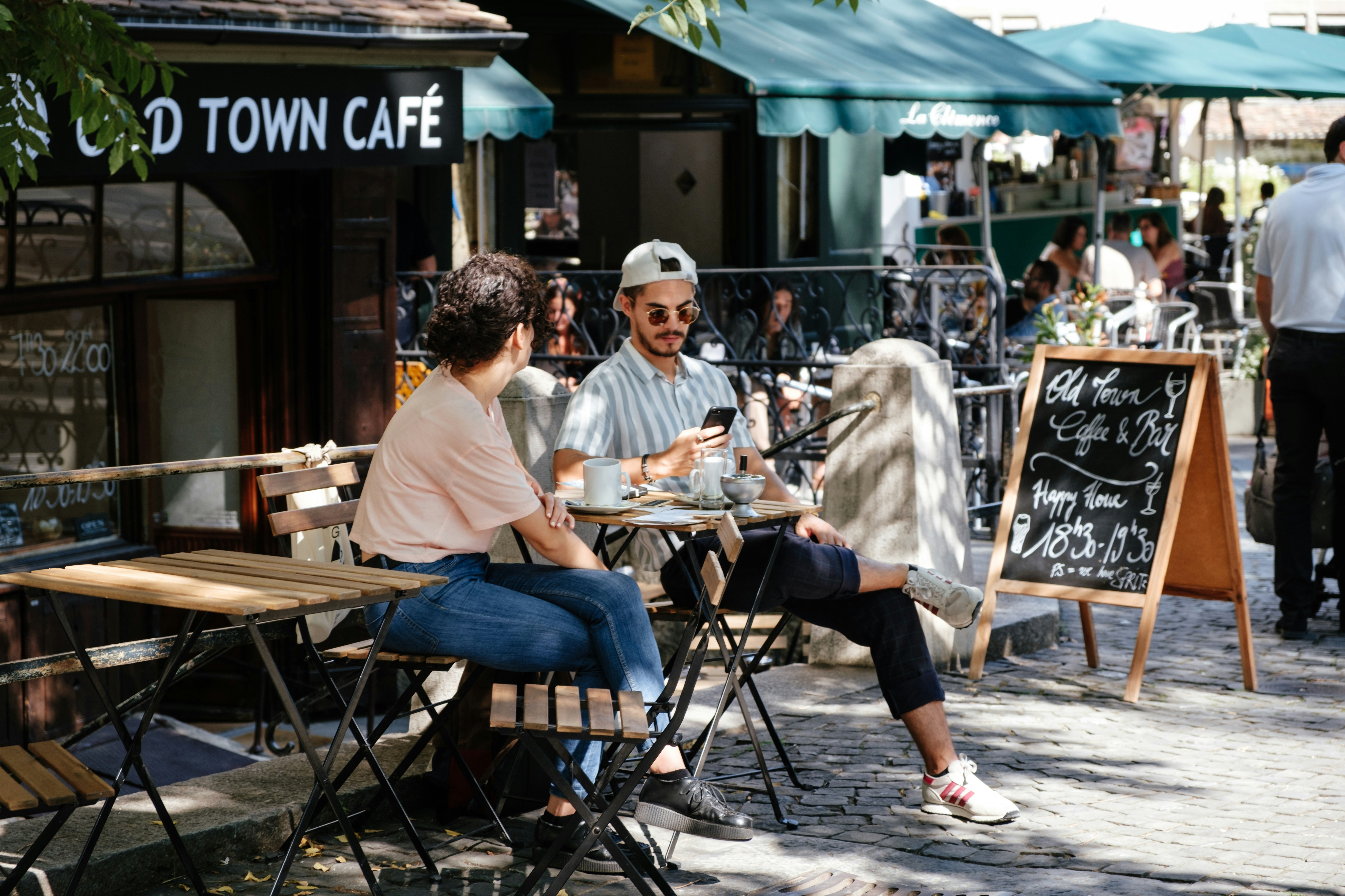 Team of three people brainstorming over a laptop in a cafe in Geneva