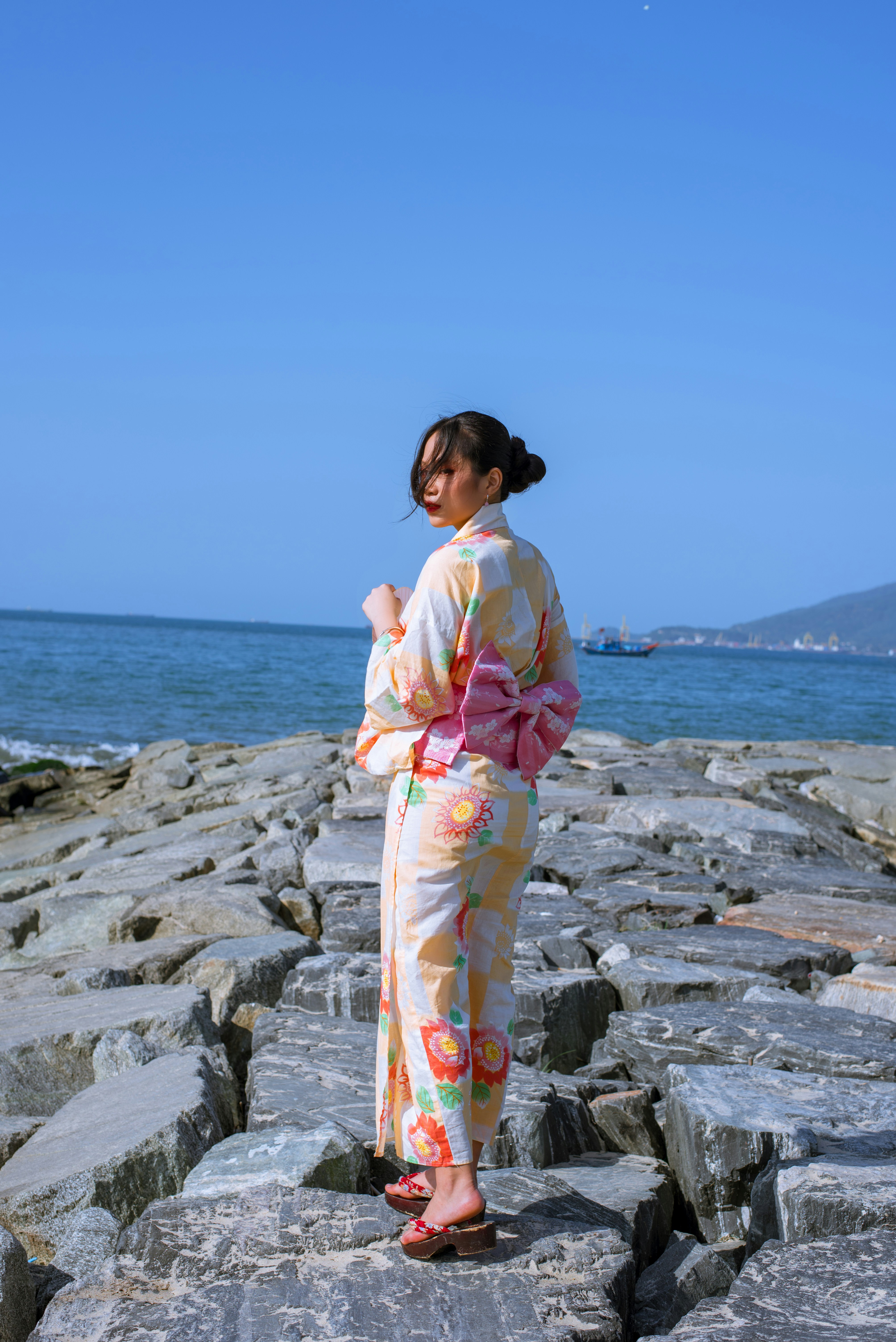 Detailed shot of a woman wearing multiple boho accessories rings and bracelets