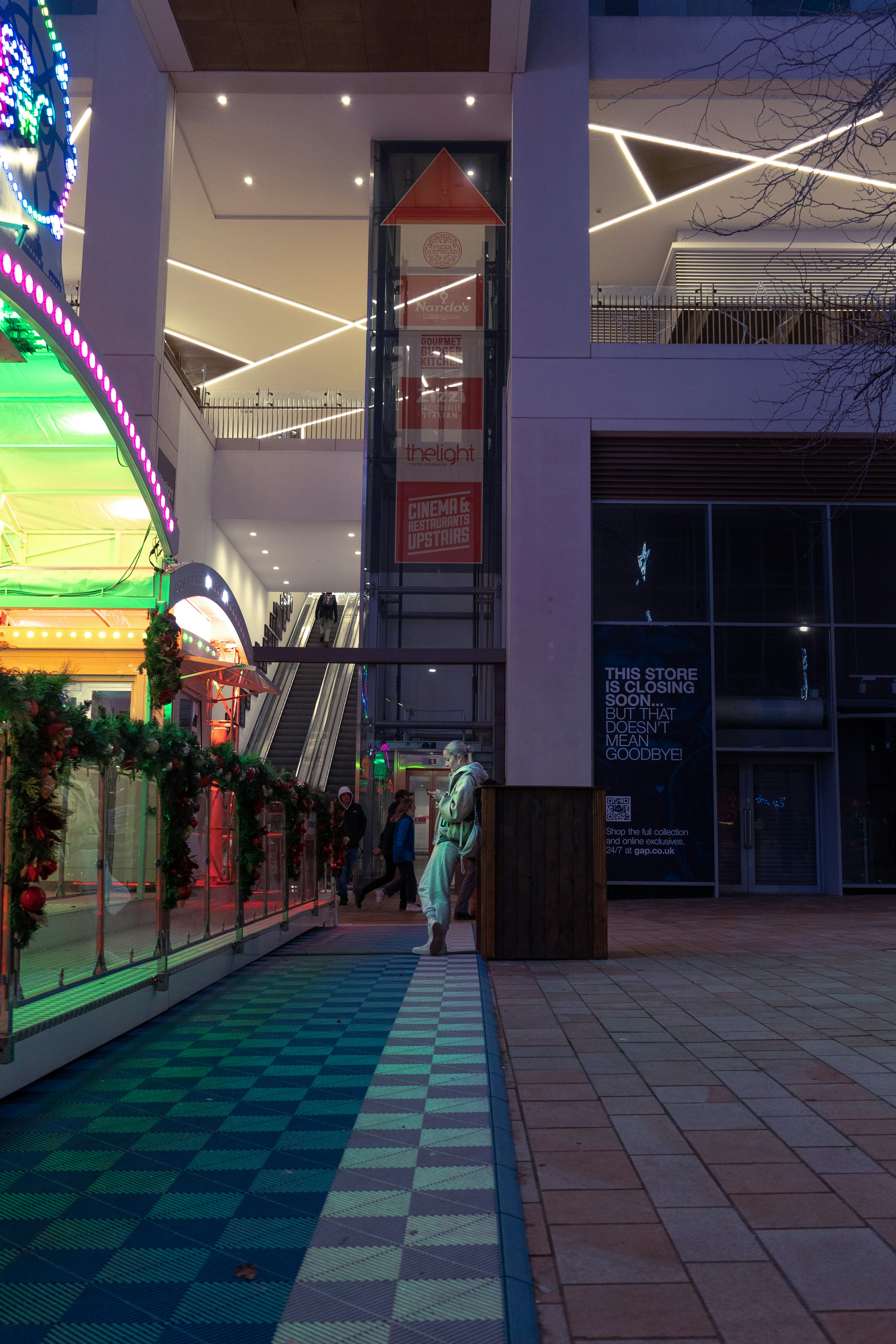 Futuristic concept of a shopping mall event with holographic displays and sustainable materials.
