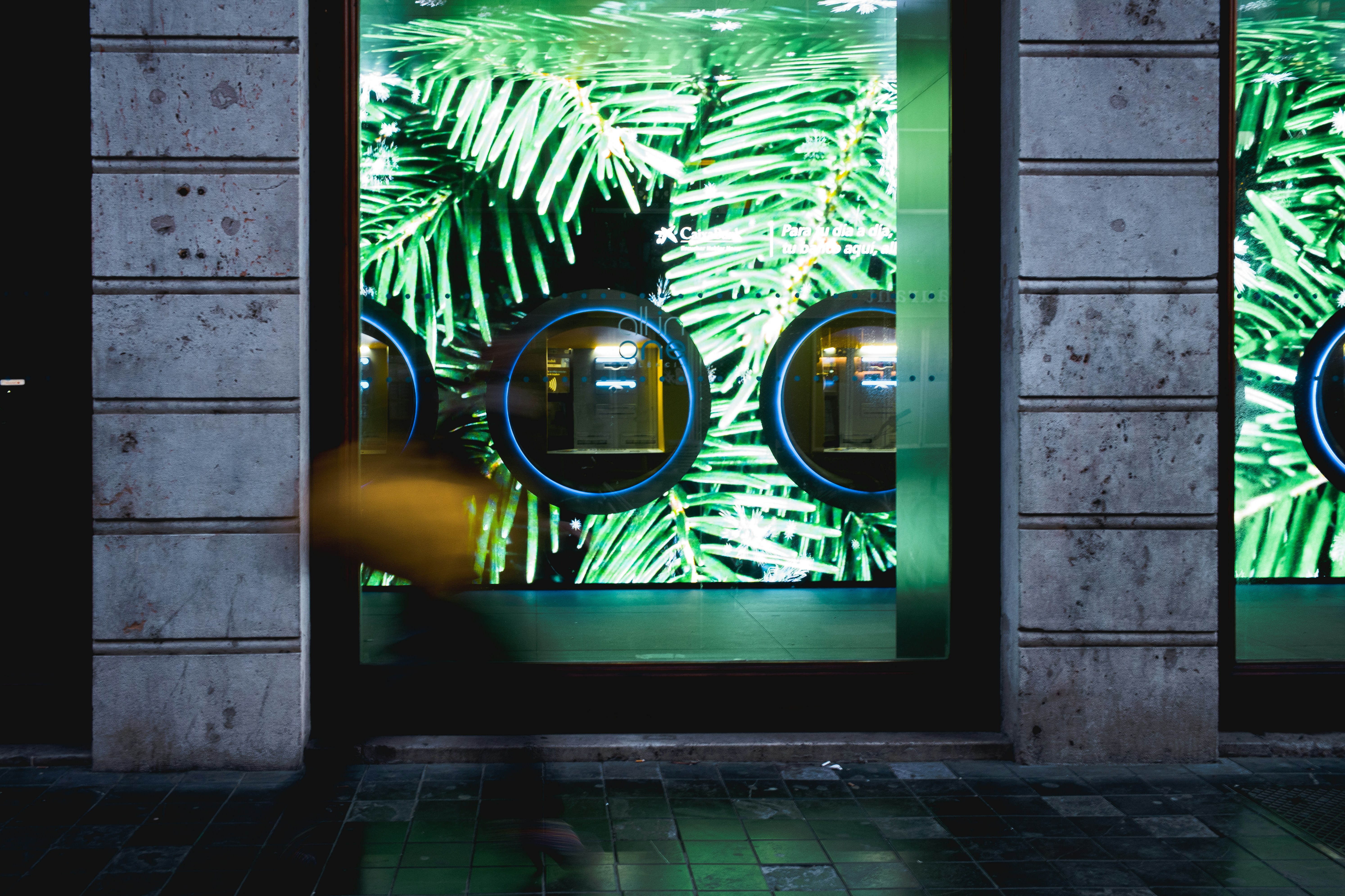 A creative digital signage wall featuring abstract art in a modern minimalist retail space