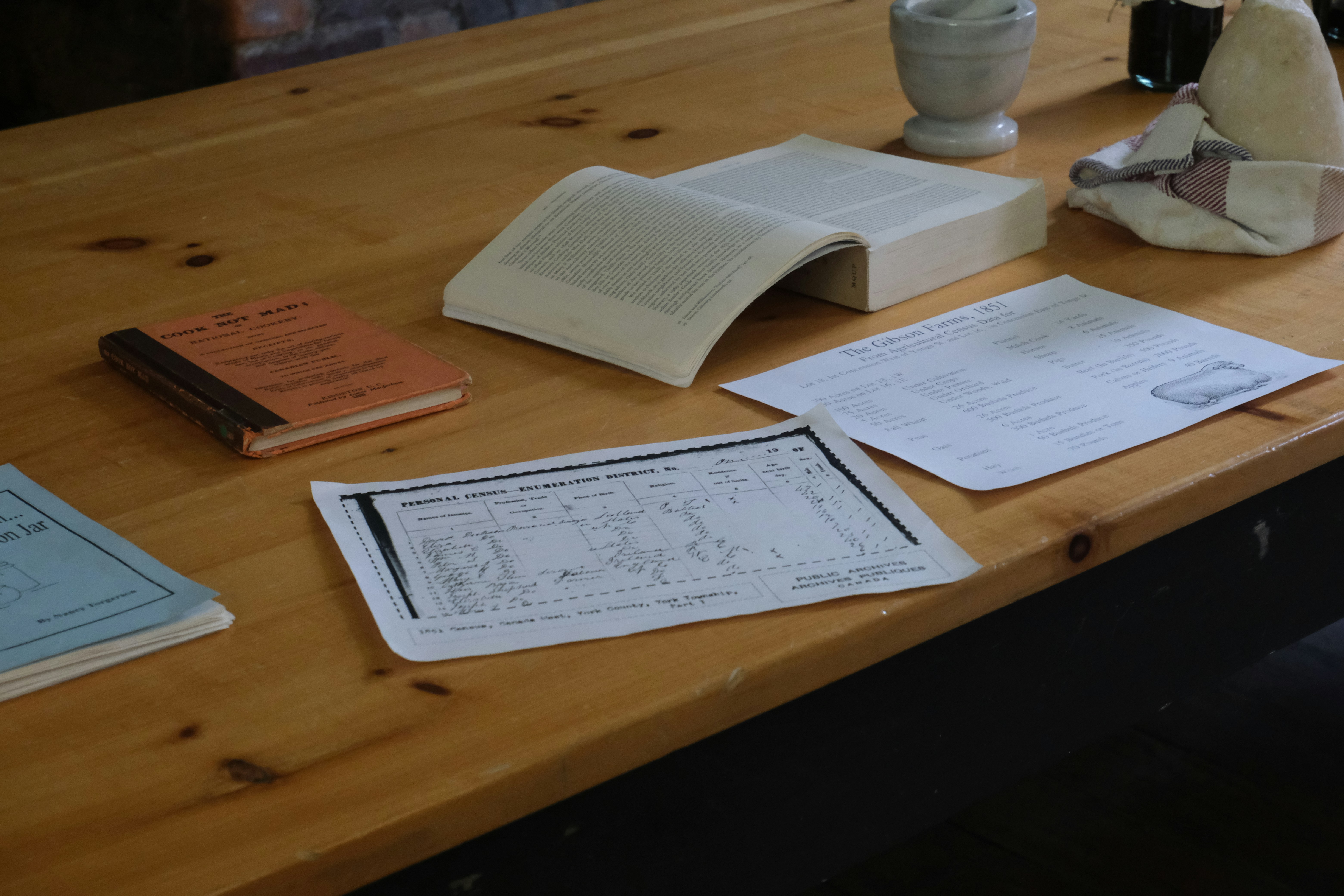 Close up of hands analyzing a business plan on a wooden table with calculator and glasses