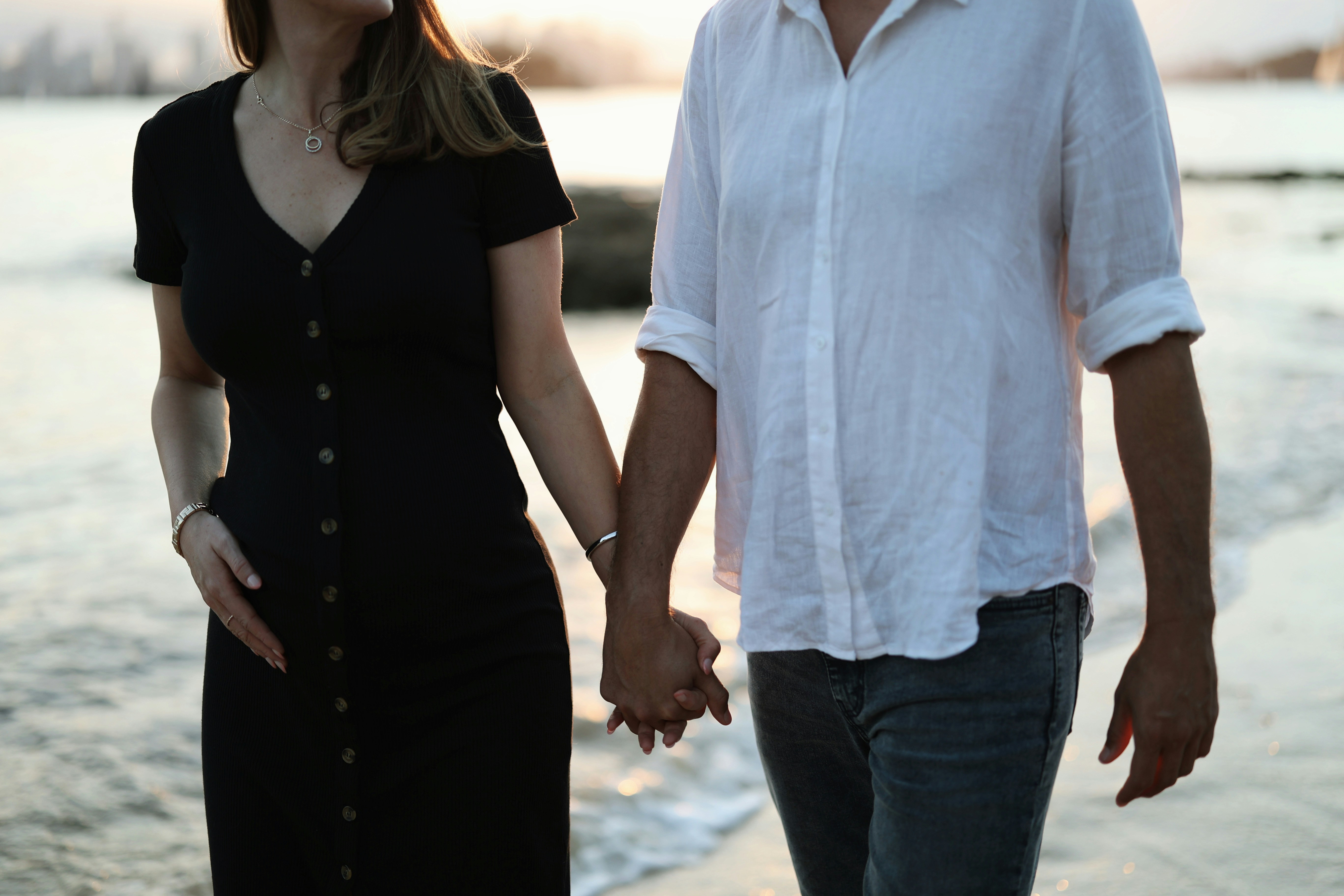 Unsplash image of a couple holding hands appearing supportive and united