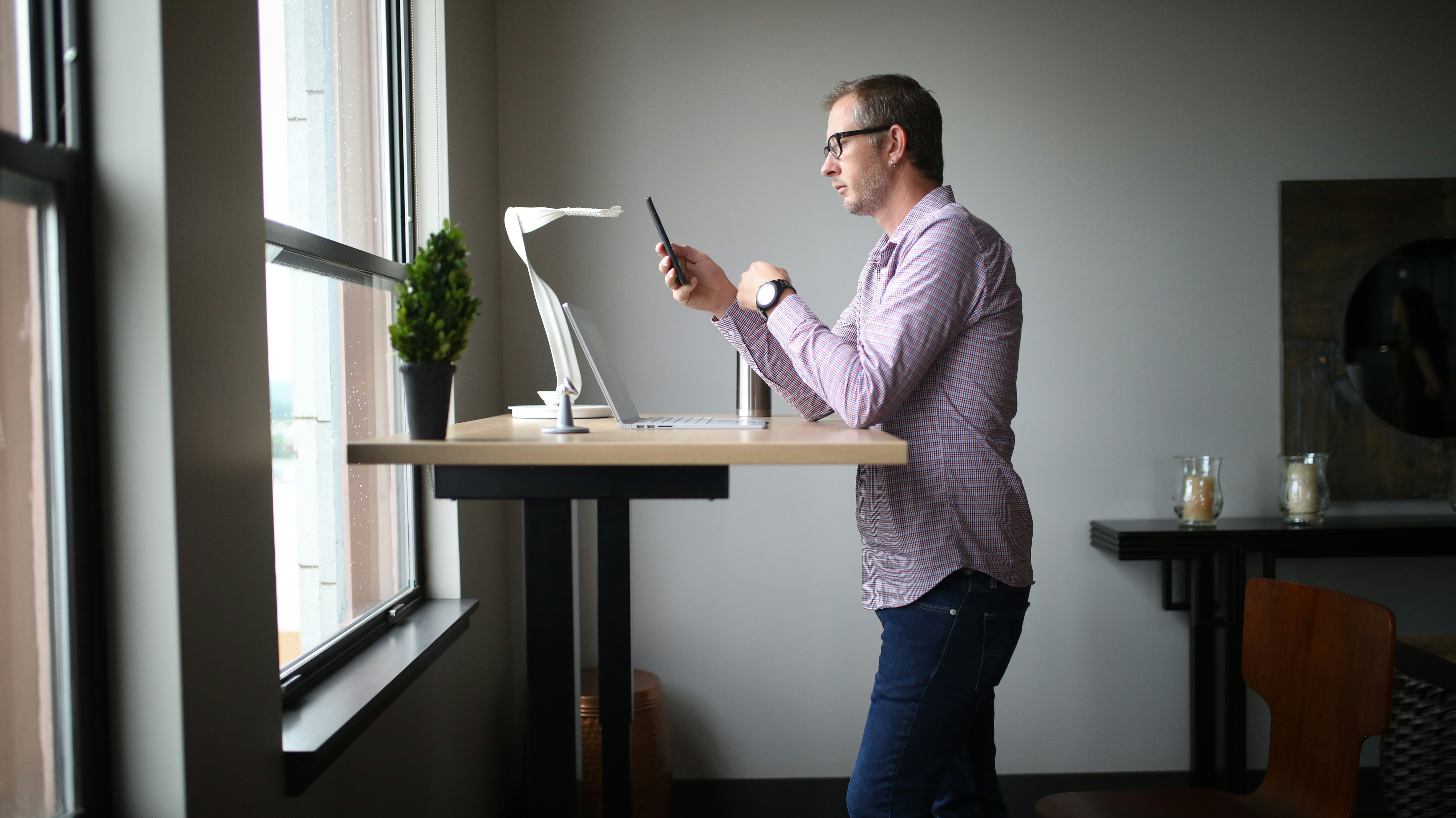 Business man analyzing growth charts on a tablet in a modern office