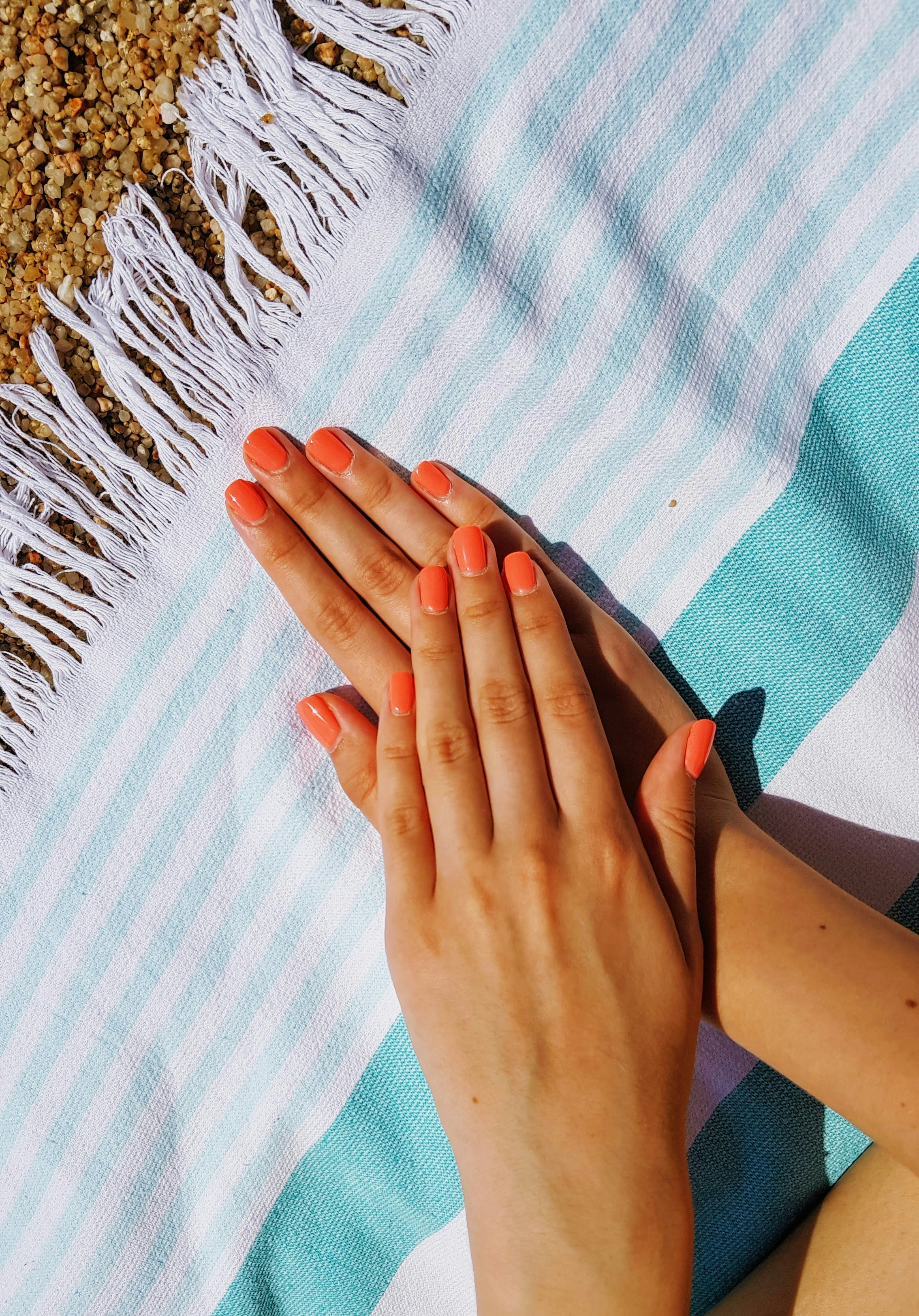 Close up of hands feeling a textured organic cotton fabric on a wooden table