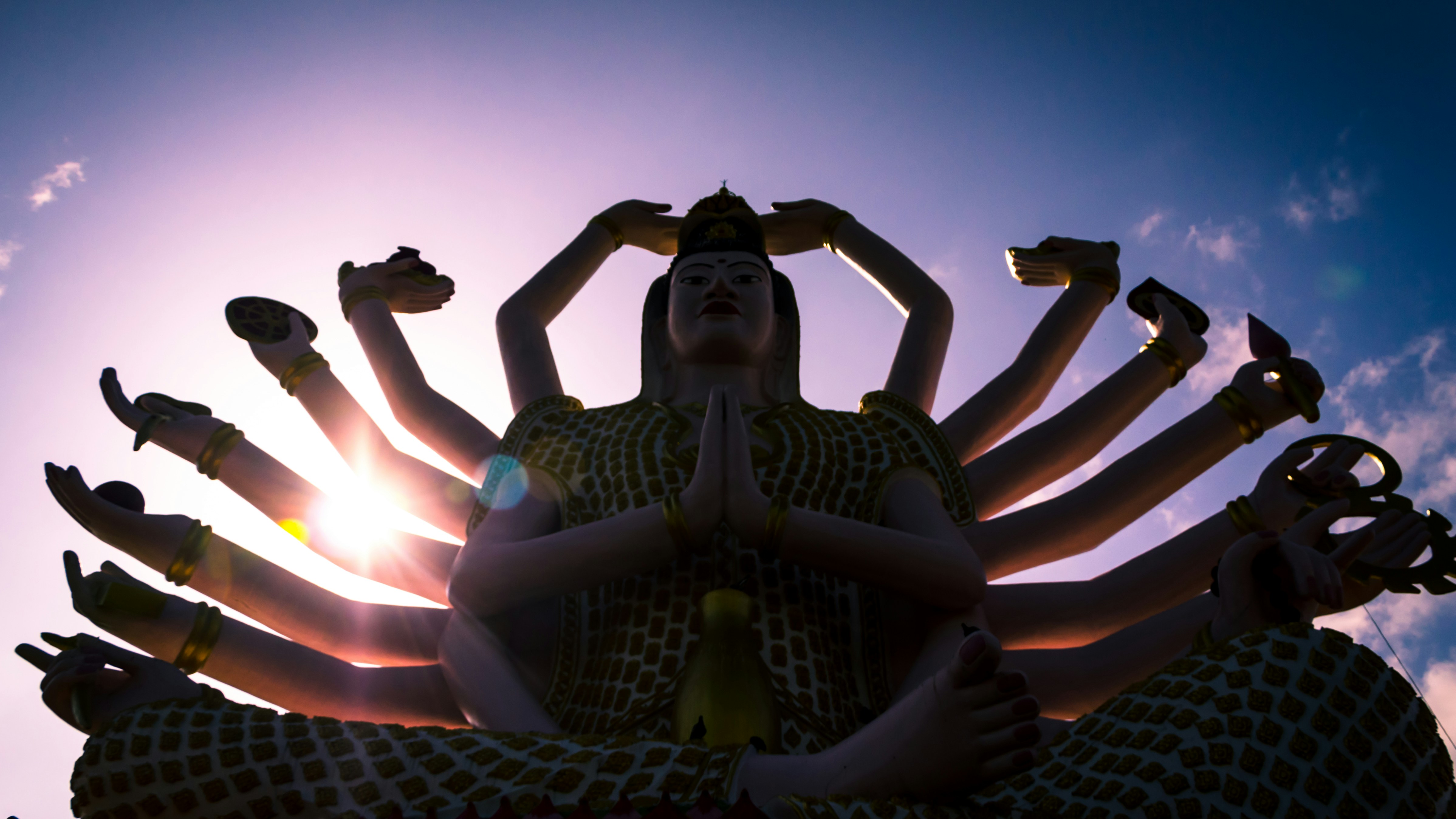 Woman meditating in a lotus position with light chakras aligned overlay representing balance inside work life