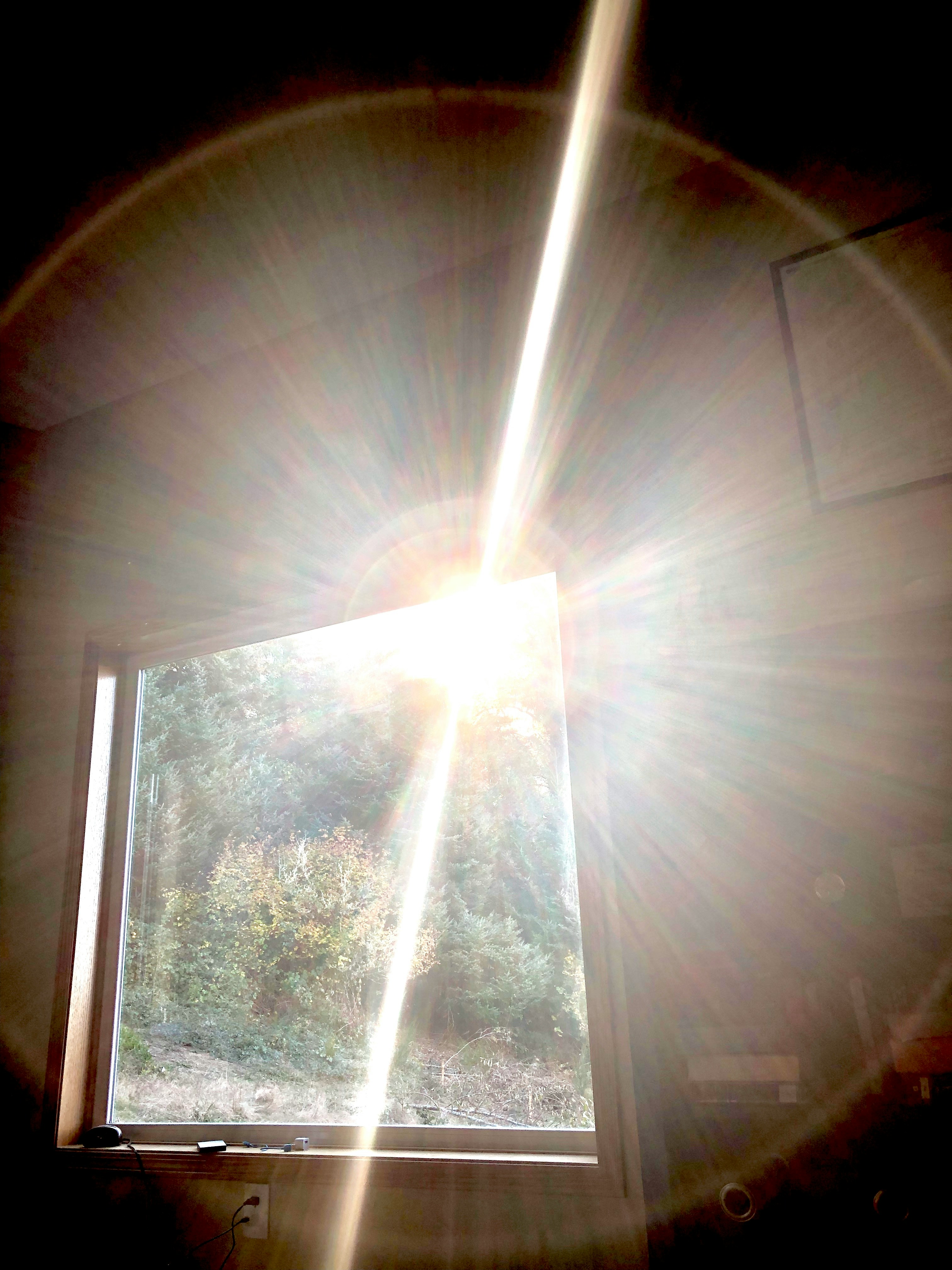 Close up of hands holding a glowing light orb representing energy healing and guidance