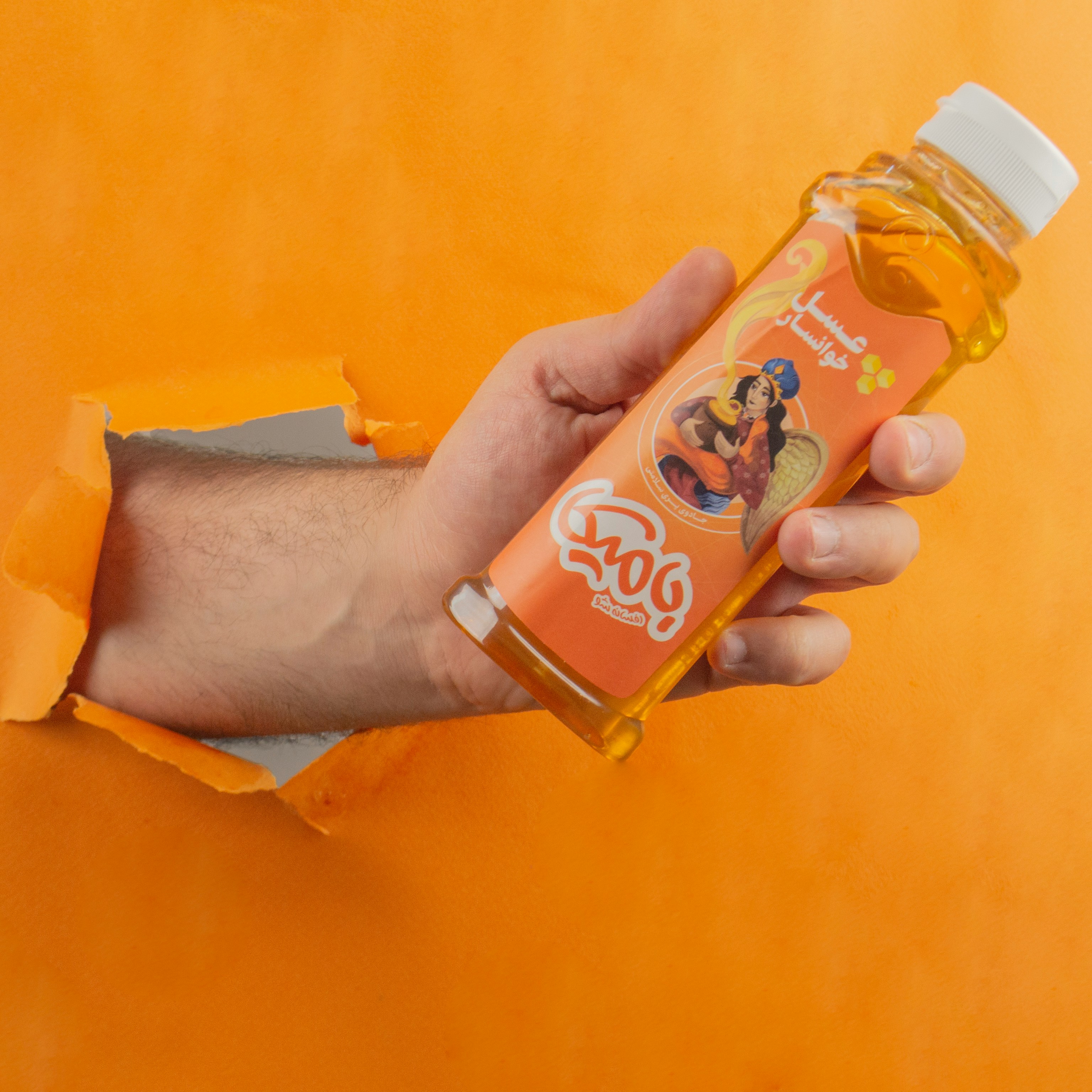 Close-up photo of a person hands holding a beverage bottle, pointing specifically at the nutrition label section.