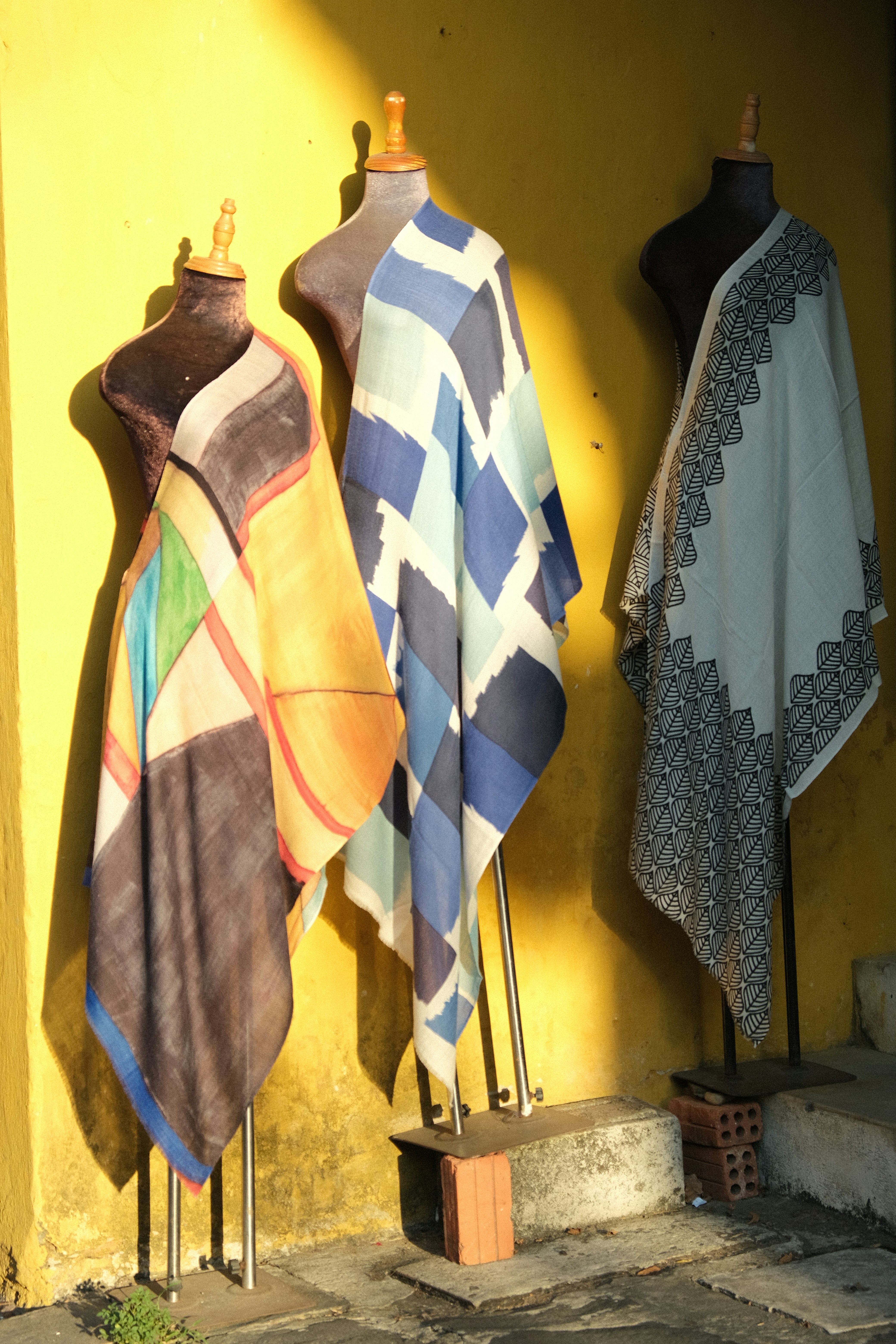 Rack of clothing in a boutique showing varied textures including silk, cotton, and vintage denim