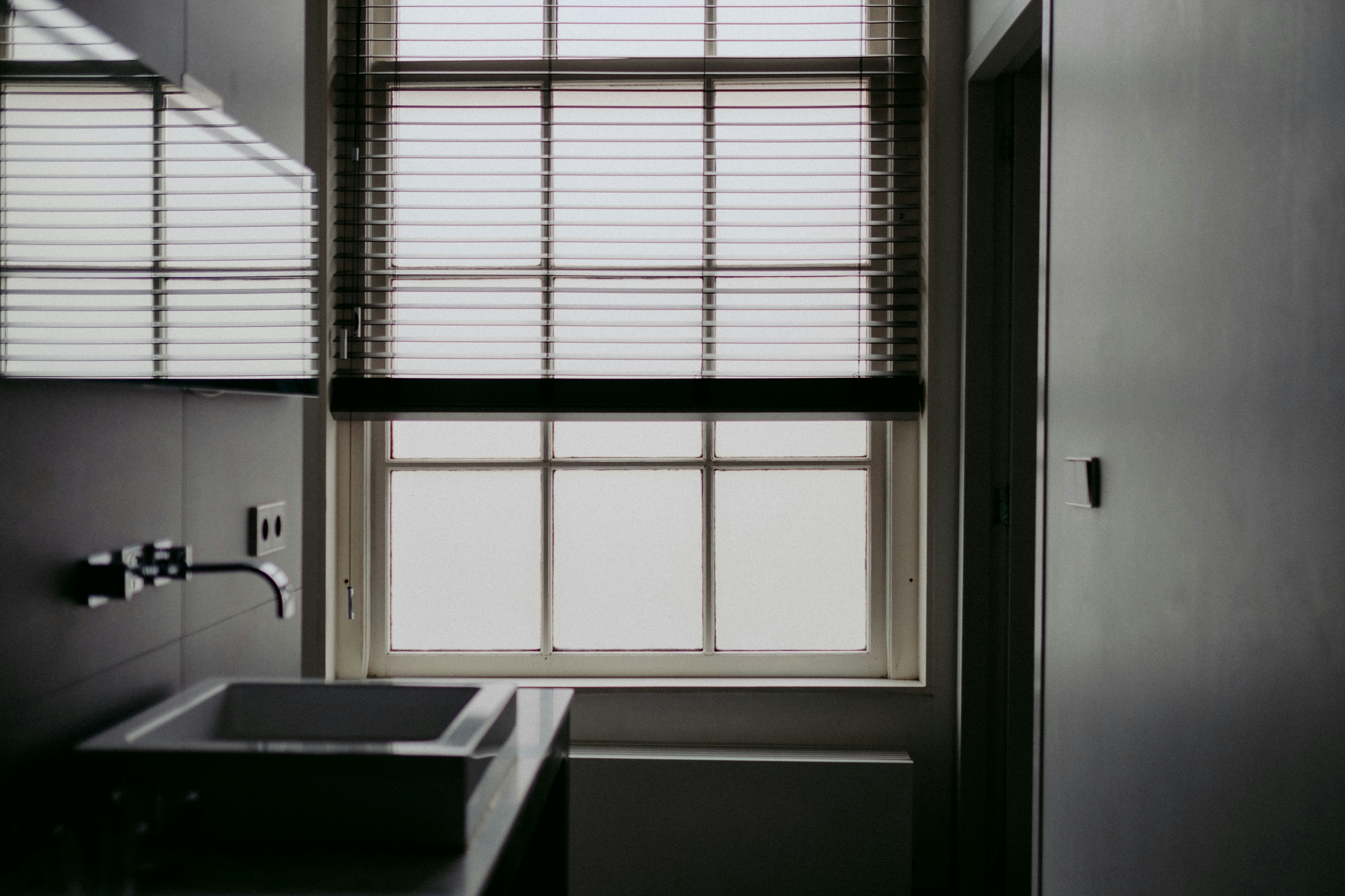 Modern minimalist bathroom with aluminum blinds resisting humidity