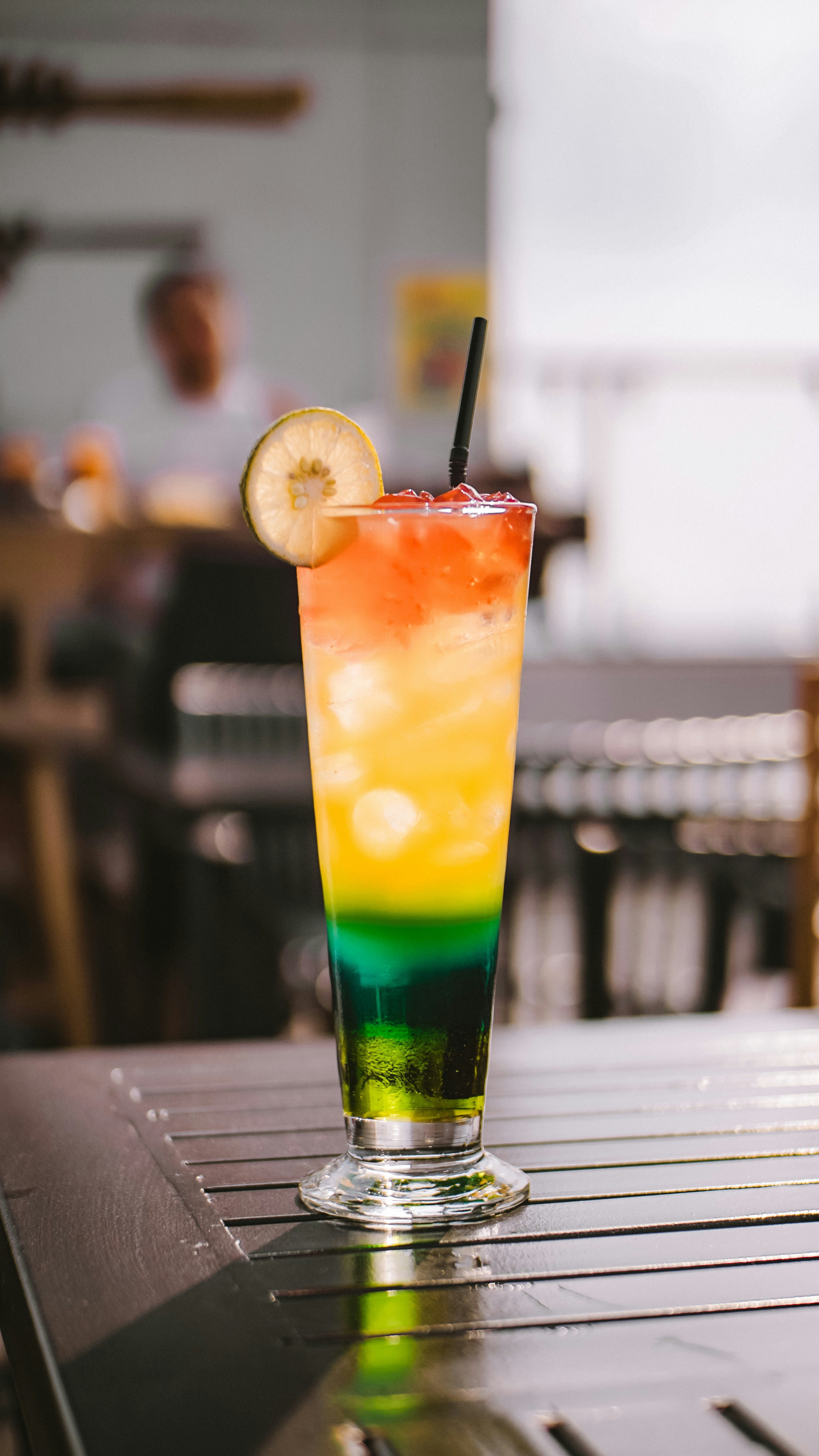 Close up of colorful cocktails on a bar counter with american style decoration in background