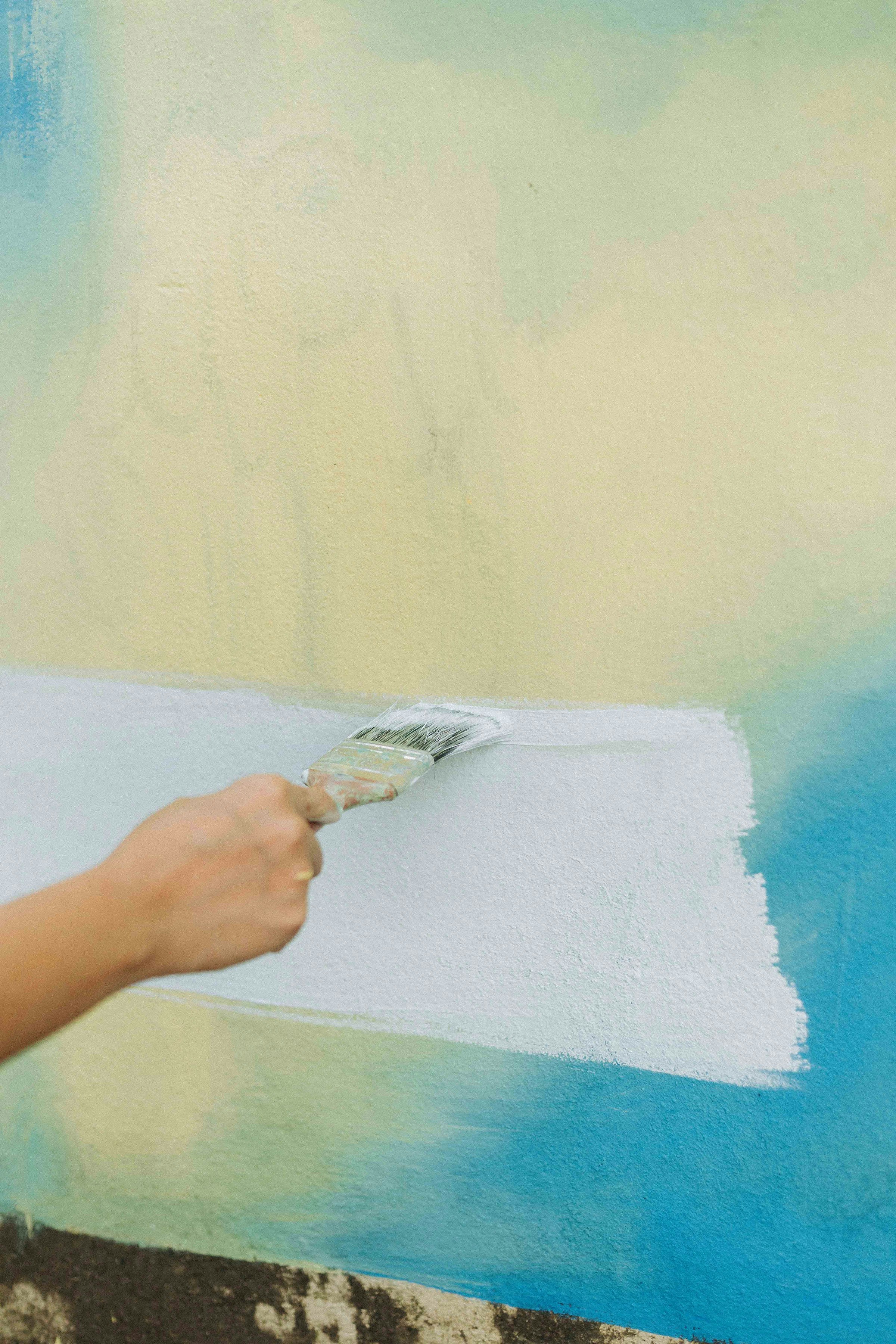 Close up of a hand smoothing a wall with plaster before painting showing texture and expertise