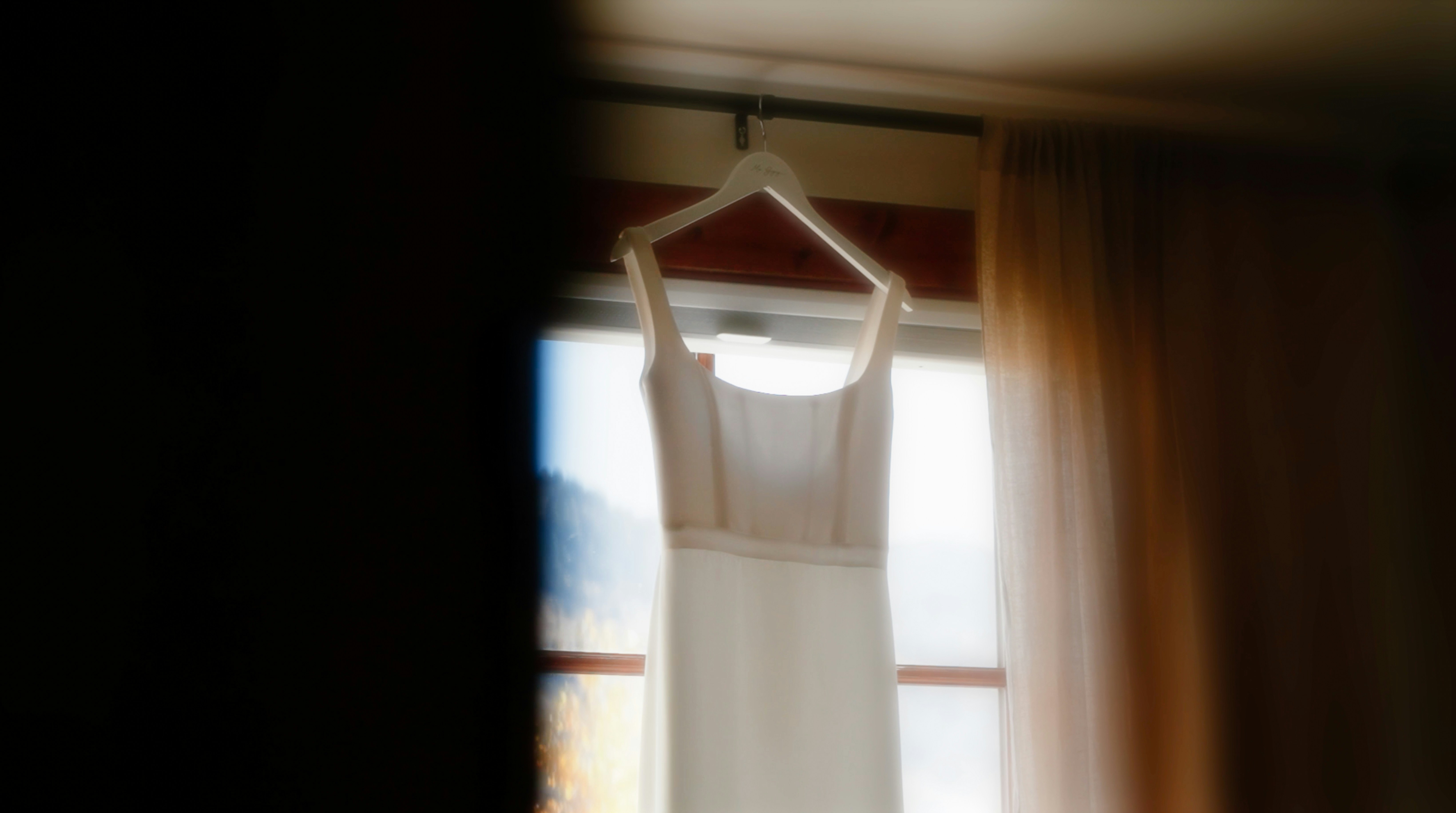 Comparison of a modern dress paired with a vintage accessory laying on a bed