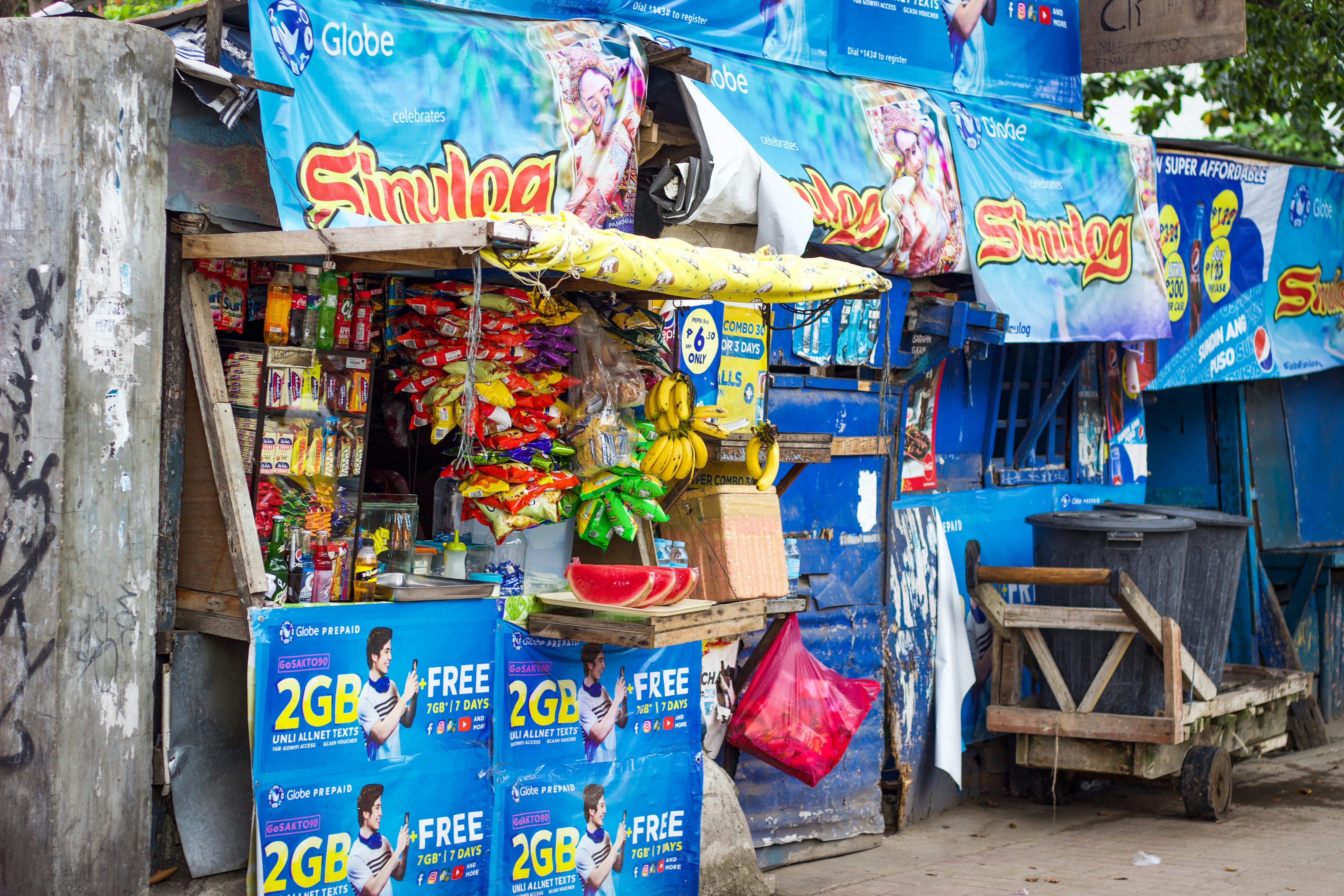 Musician selling merchandise cds and stickers on a small table next to performance area