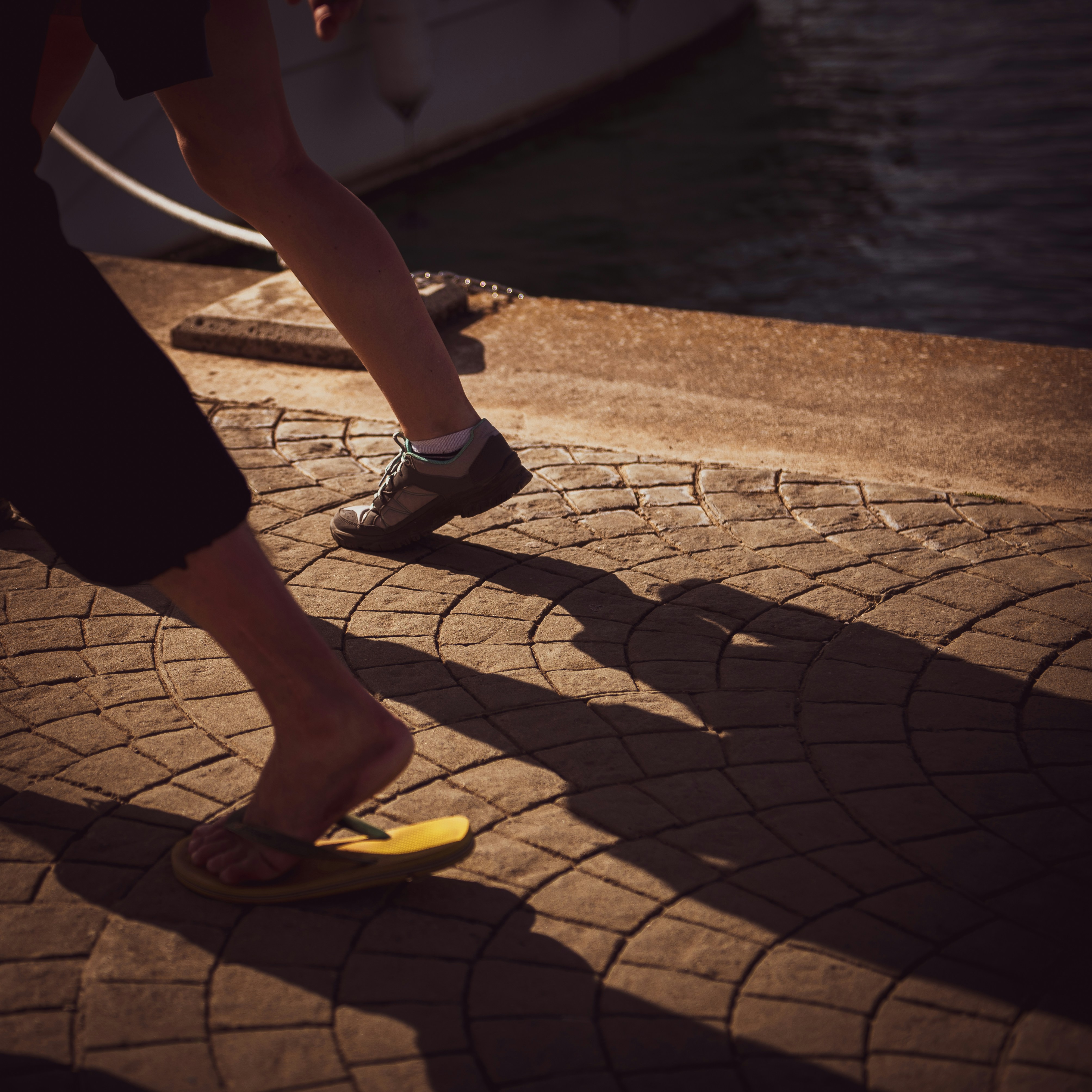 Man tying running shoes preparing for a workout outdoors looking determined