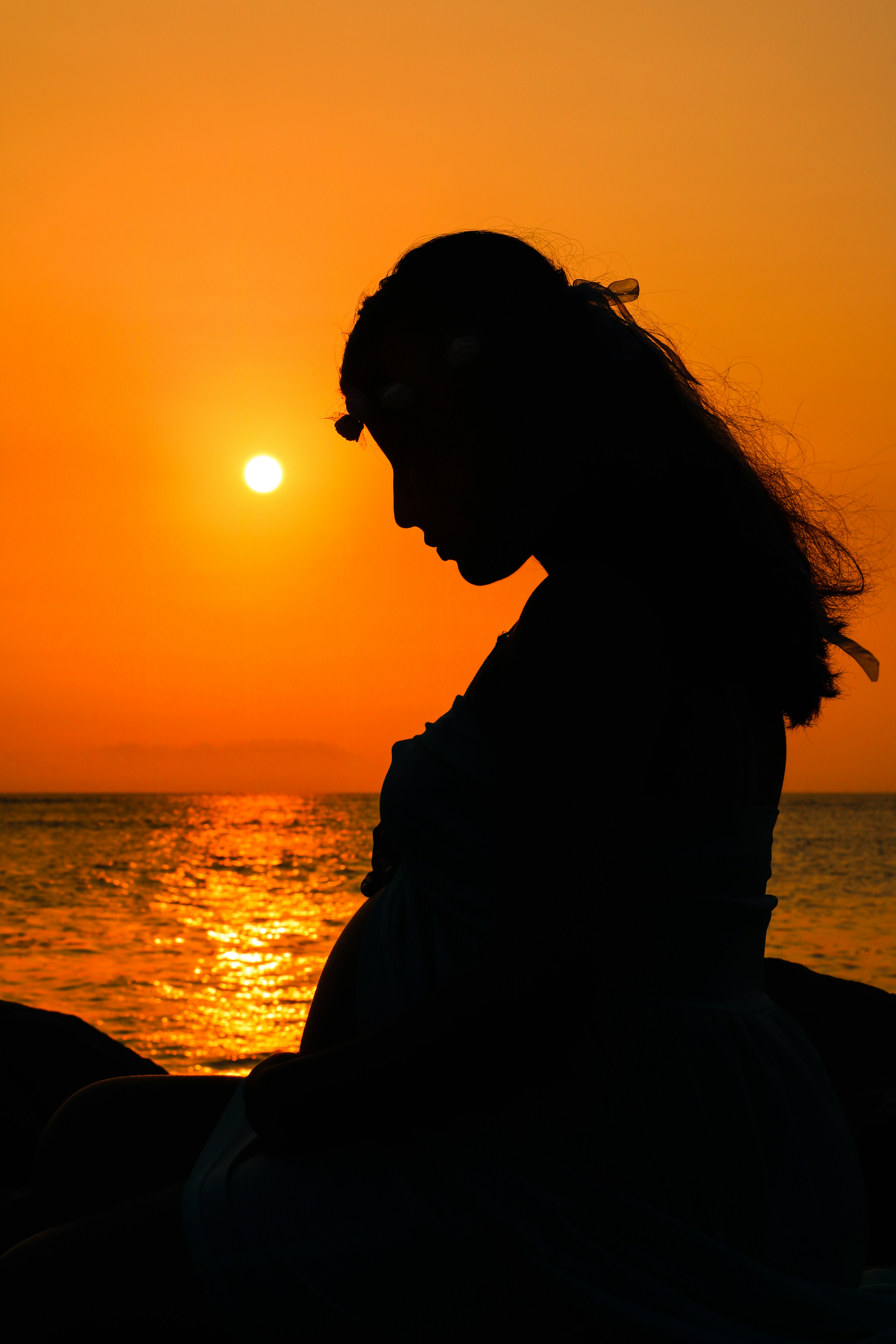 Gentle osteopathy session with a pregnant woman, focusing on comfort and emotional support.