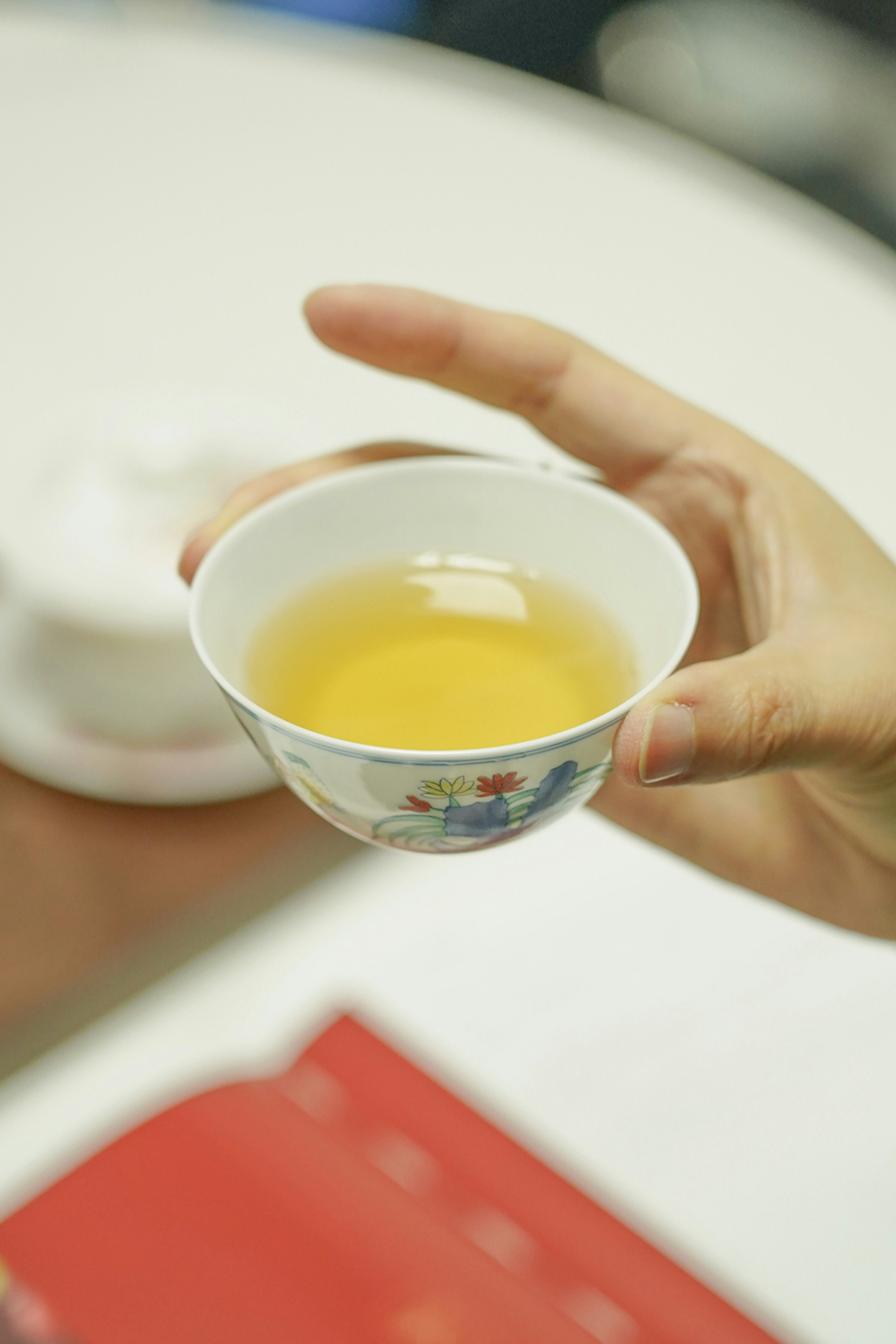 Hands holding a warm cup of herbal tea, representing comfort and stabilization phase